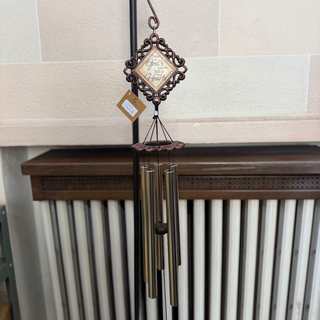 Decorative wind chime with a heart-shaped plaque and metal tubes