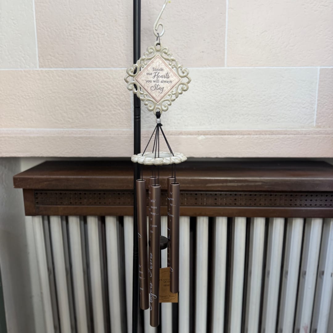 Decorative hanging wind chime with a heart-shaped plaque and brown tubes