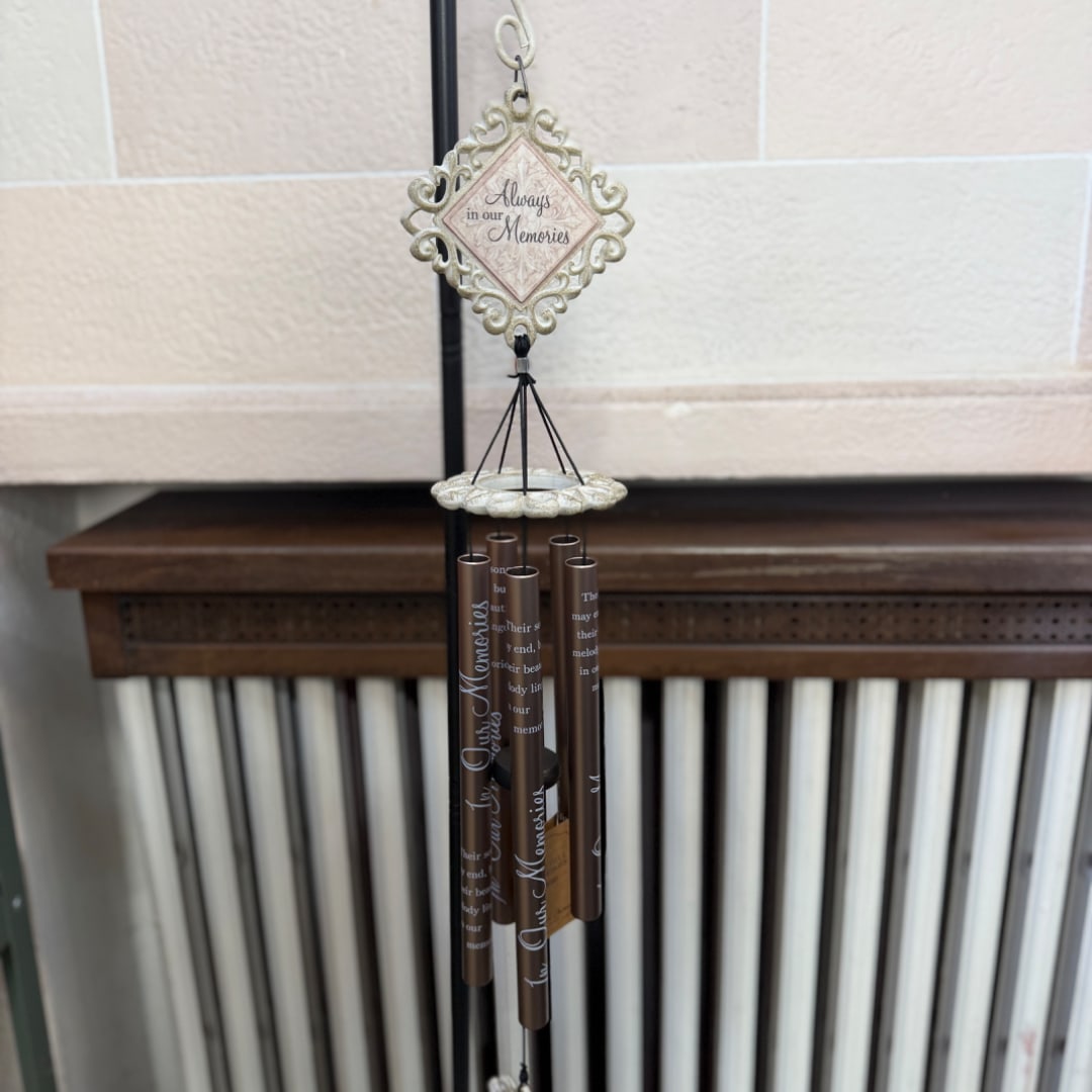 Memorial wind chime with a decorative plaque and hanging tubes