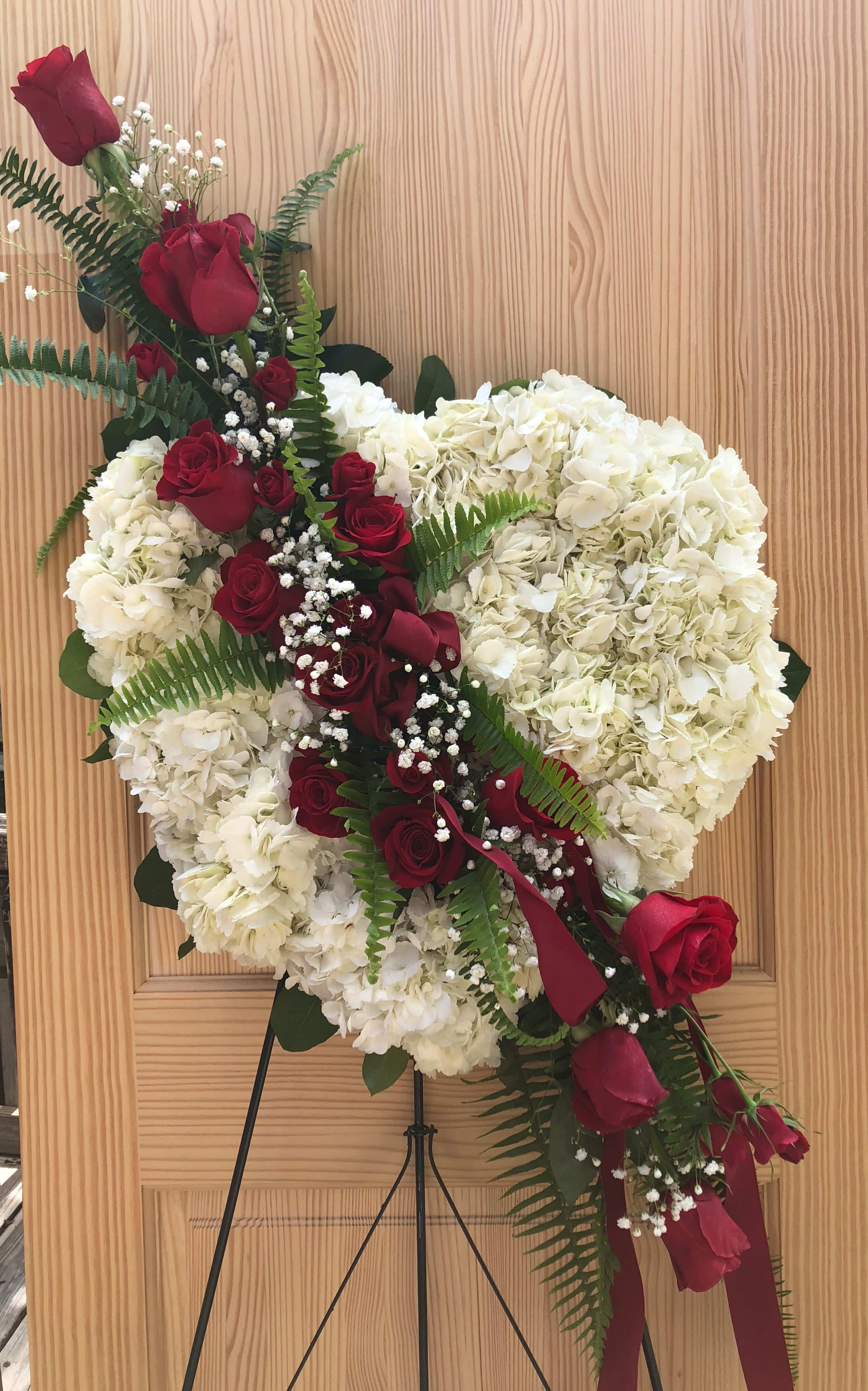Heart-shaped floral wreath with red roses and white hydrangeas