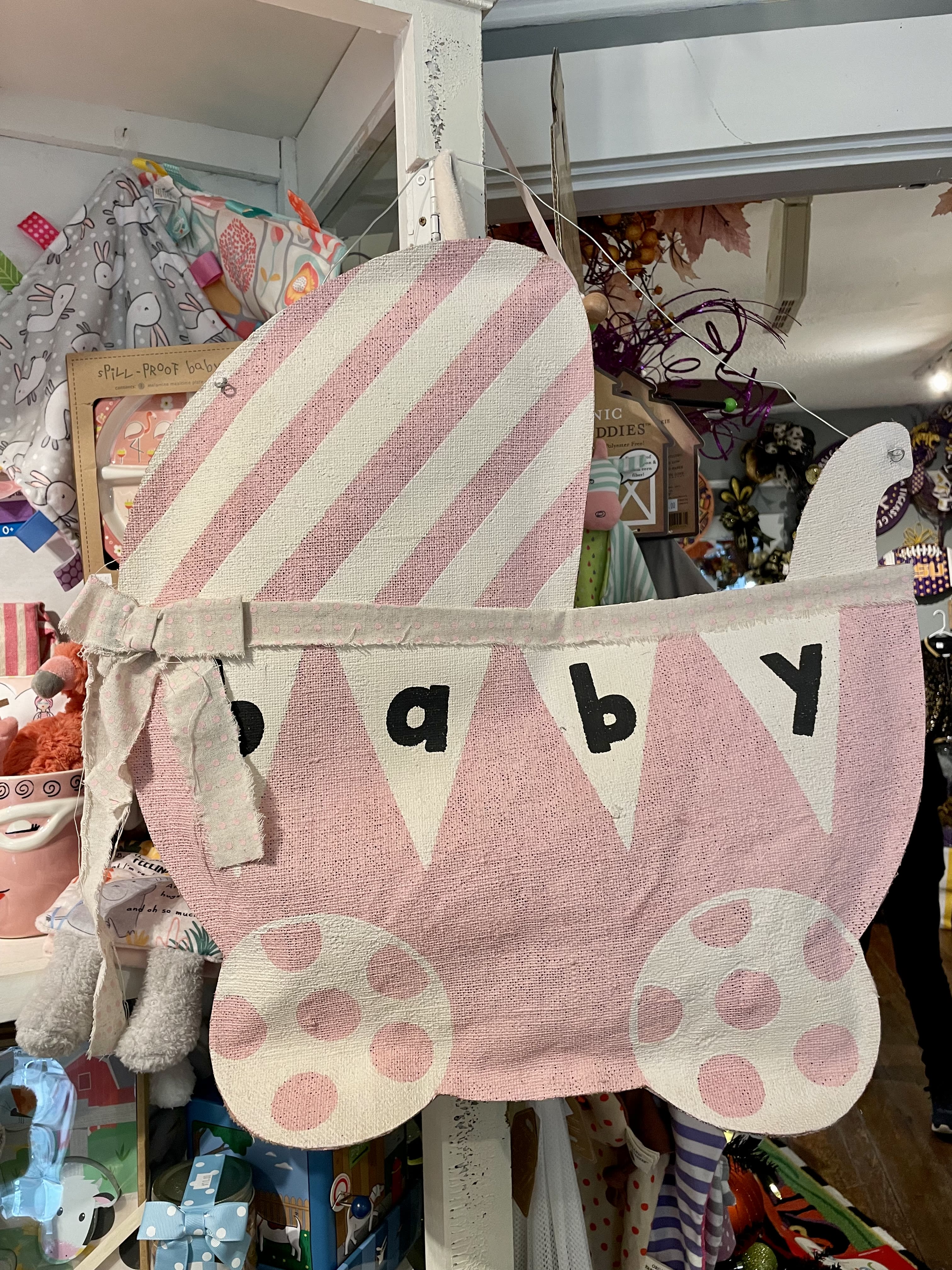 Pink fabric baby carriage wall hanging with polka dots and bunting