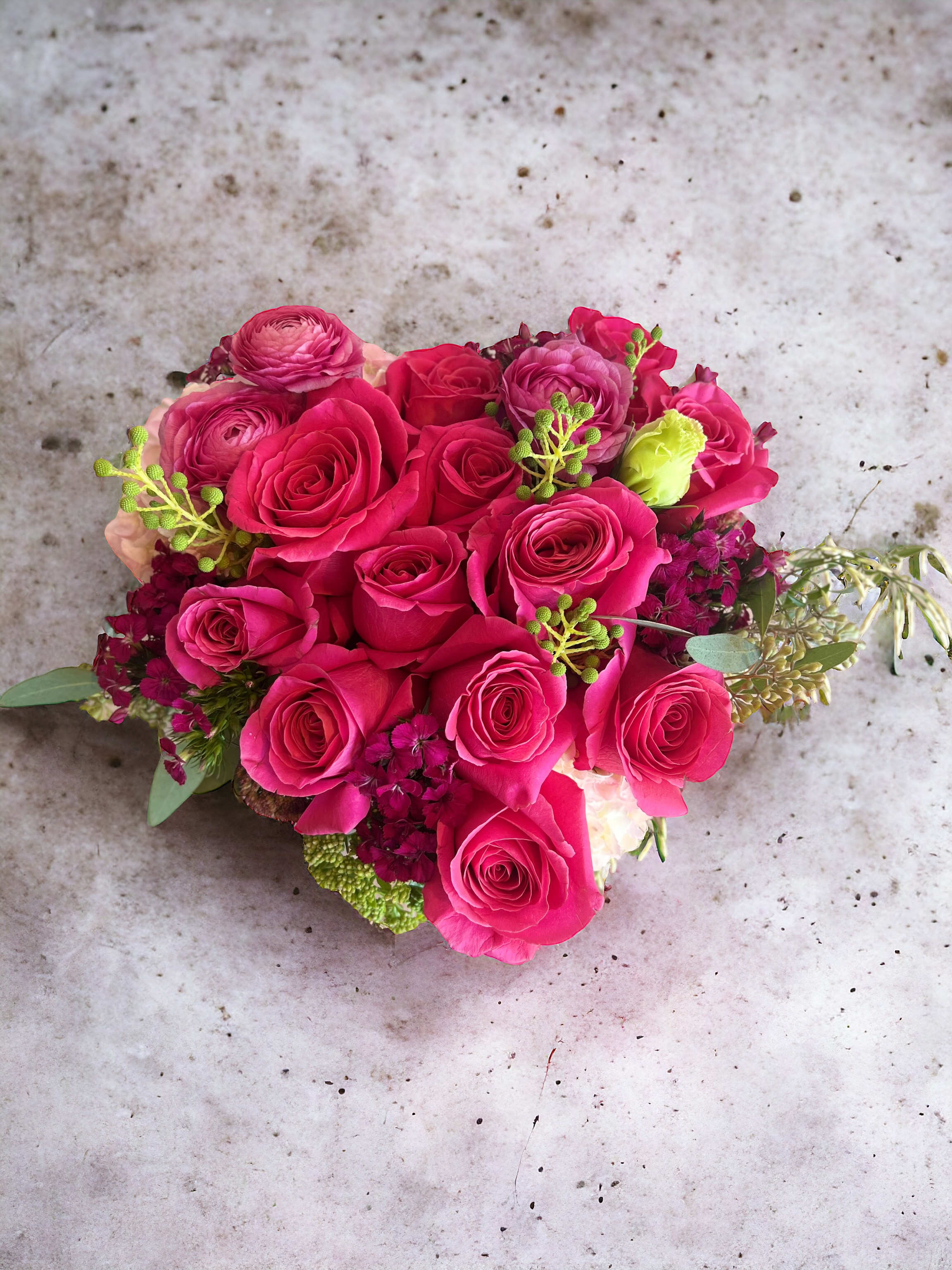 Hot pink rose bouquet with small accent flowers