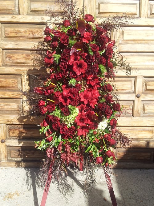 Tall red floral standing spray with roses and lilies