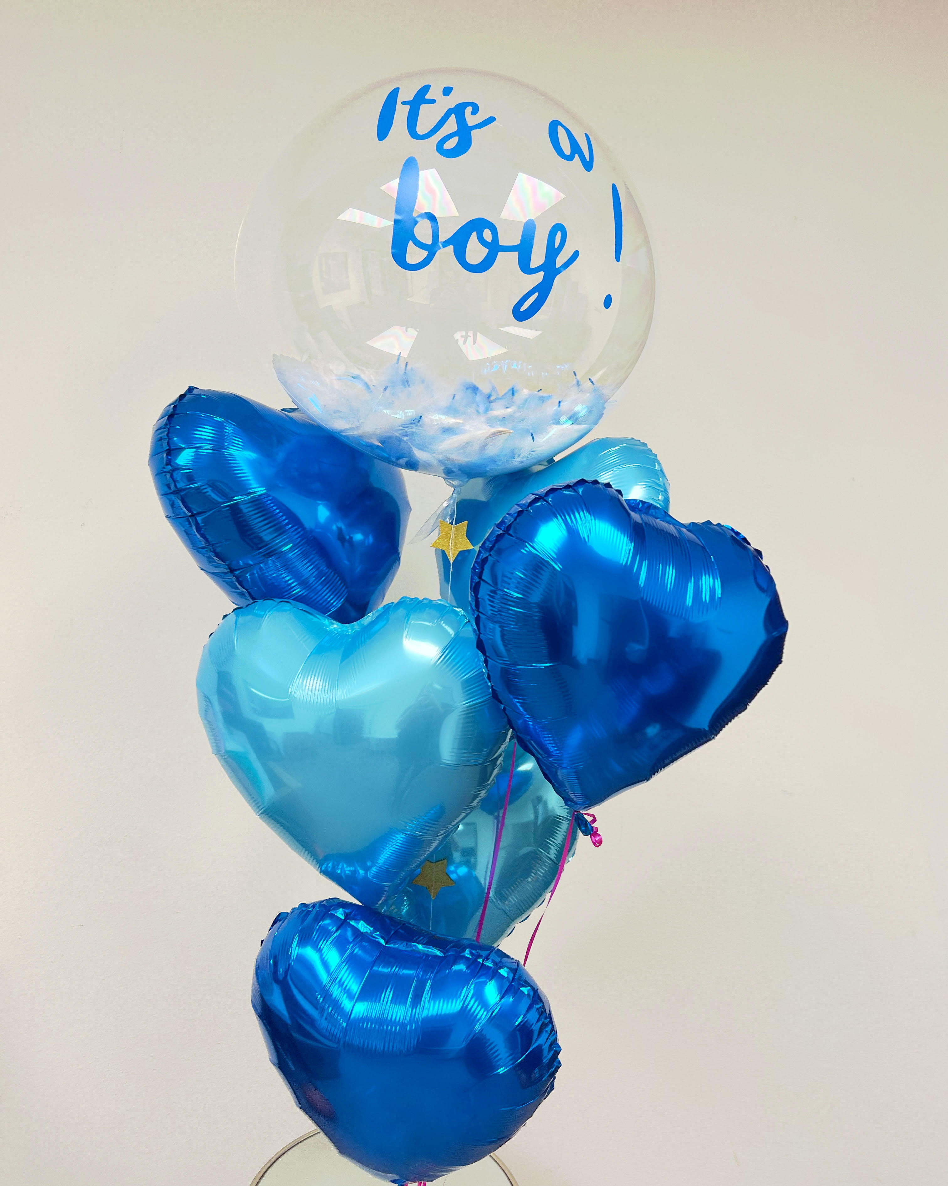 Blue heart balloons with a clear balloon reading "It's a boy!"