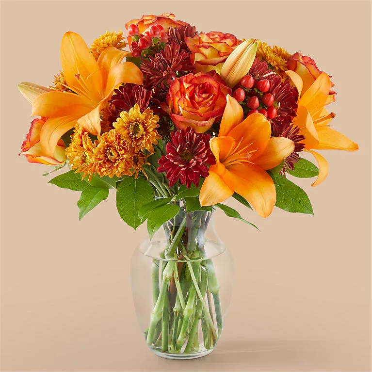 Autumnal Aroma Bouquet - Breathe in the change of seasons with this alluring blend of oranges and reds, featuring standout stems like lilies, roses and mums.