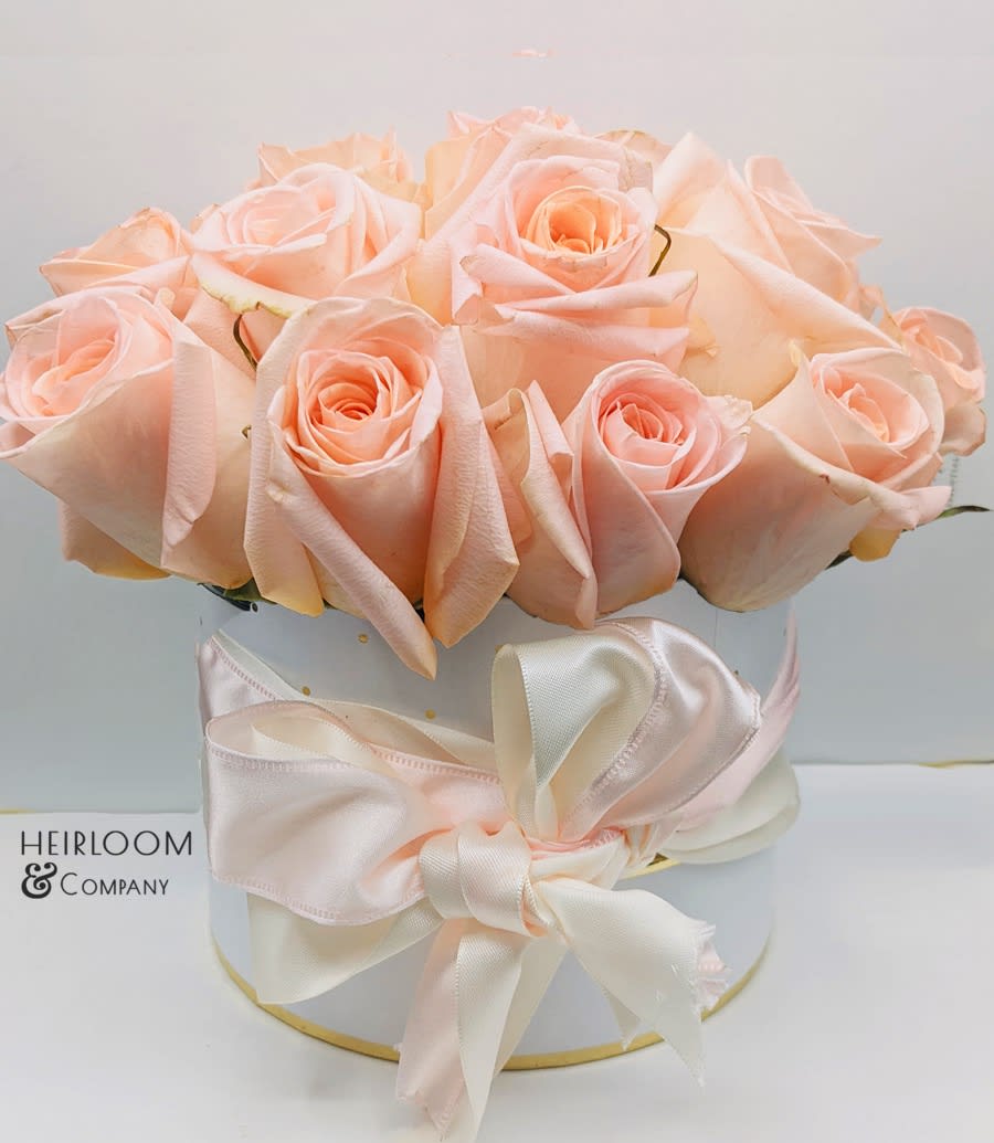 Bouquet of pale peach roses in a white hat box with a satin ribbon