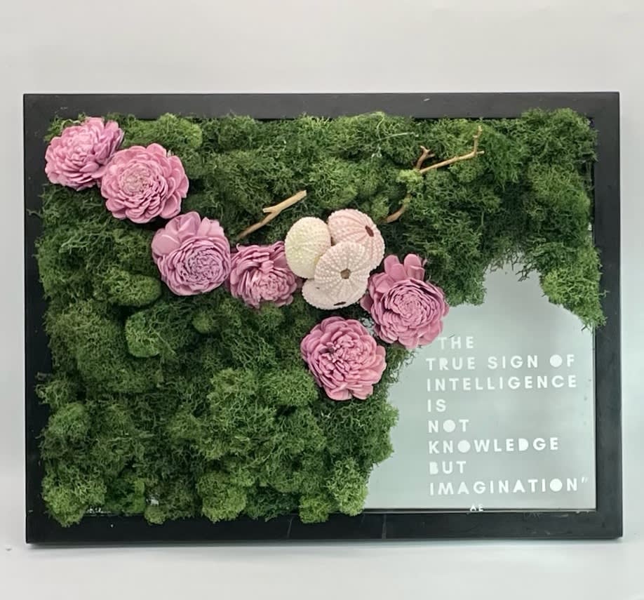 Framed moss wall with pink flowers and a quote panel