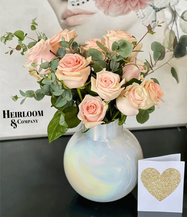 Blush roses in a white vase with a glitter heart card