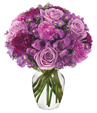 Purple rose bouquet in a clear glass vase