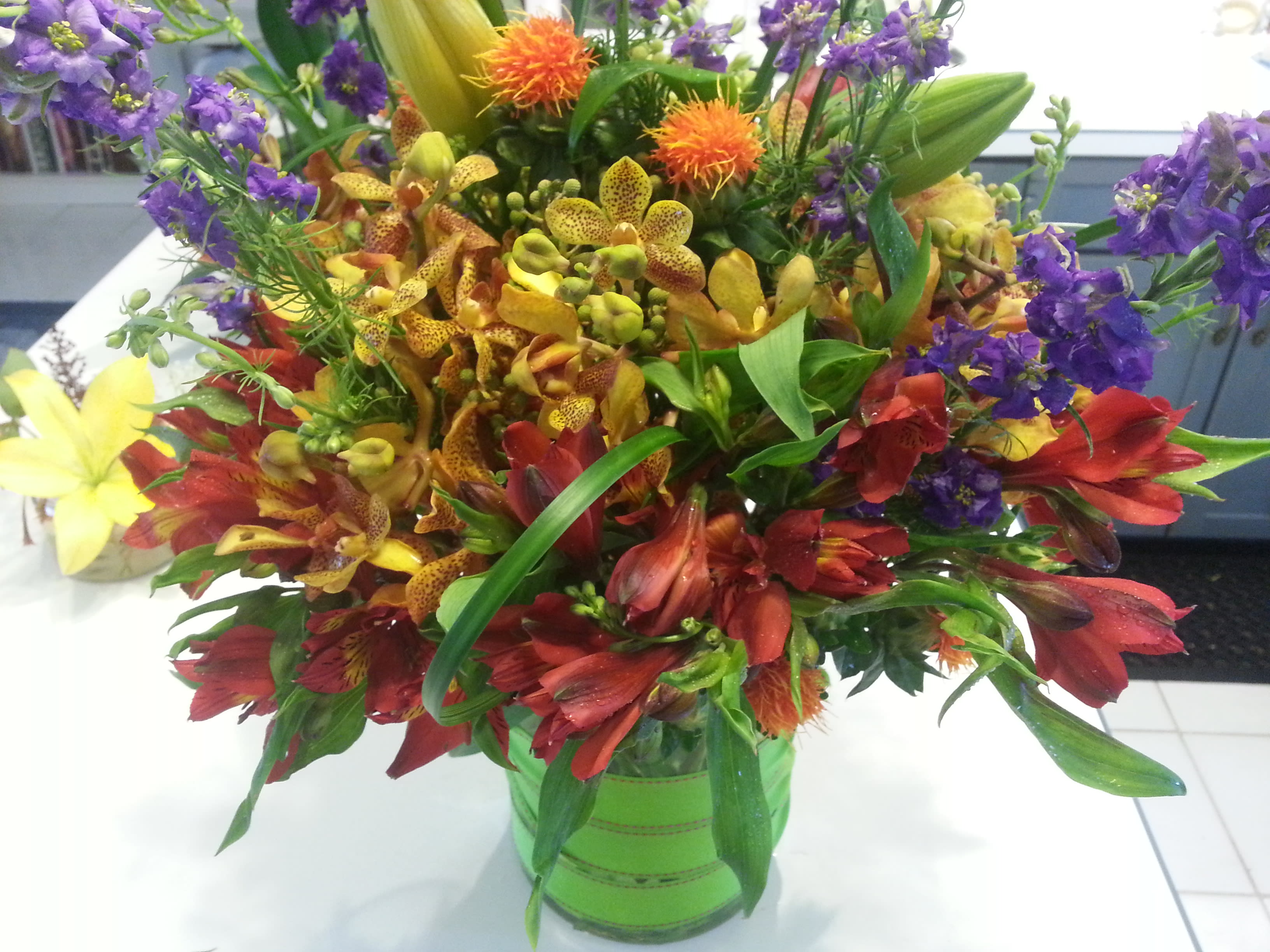 Falling for You - Safflower, Dendrobium Orchids, altstromeria, larkspur and lilies create a resounding floral masterpiece.
