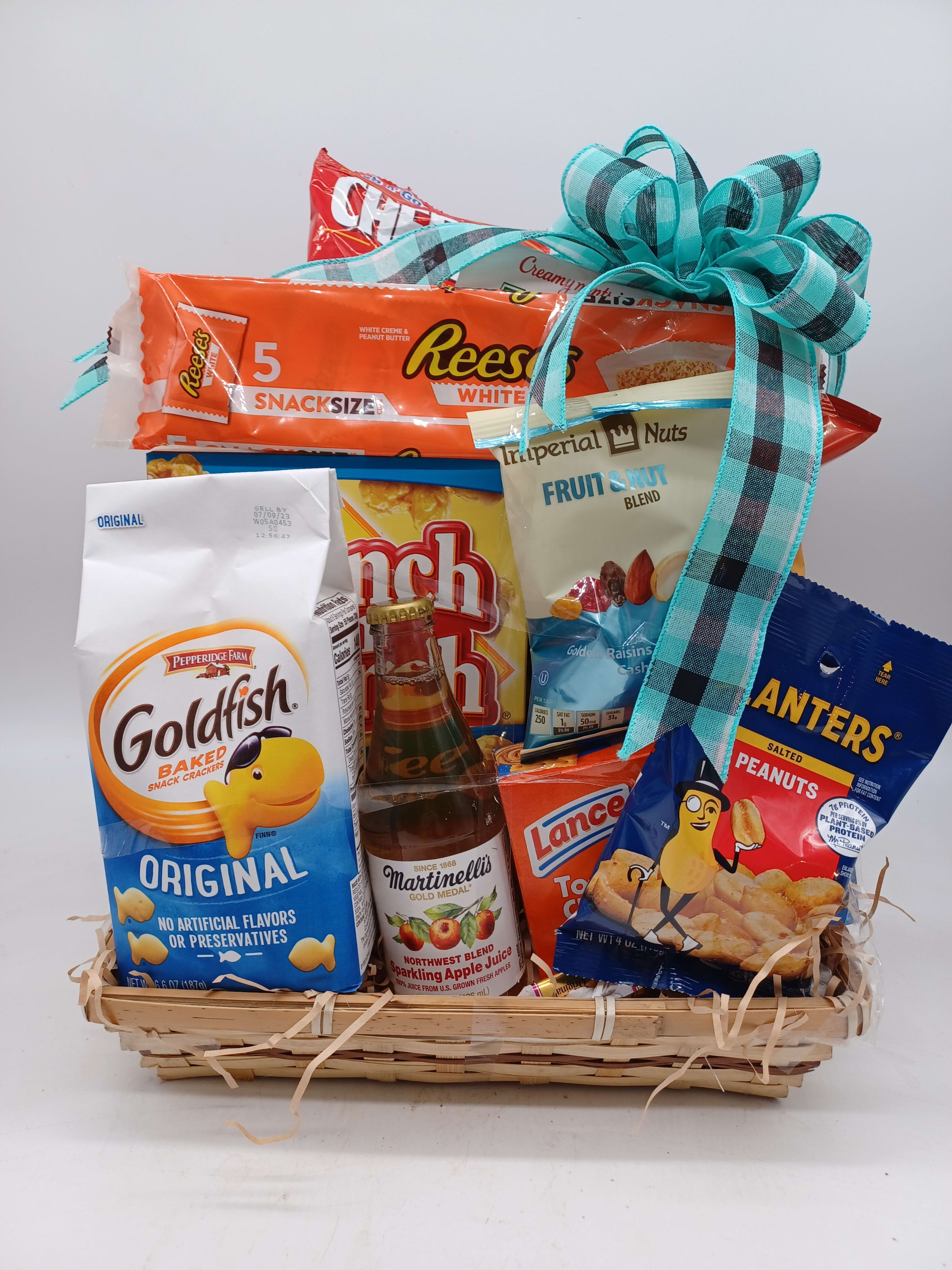 Gift basket of snacks and sparkling juice with a blue ribbon