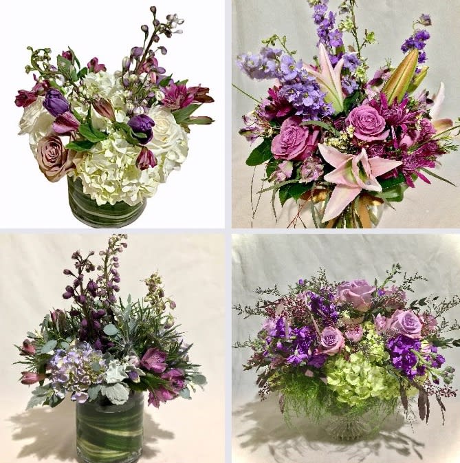 Four purple and white mixed flower arrangements in clear glass vases with roses, hydrangeas and accent blooms.