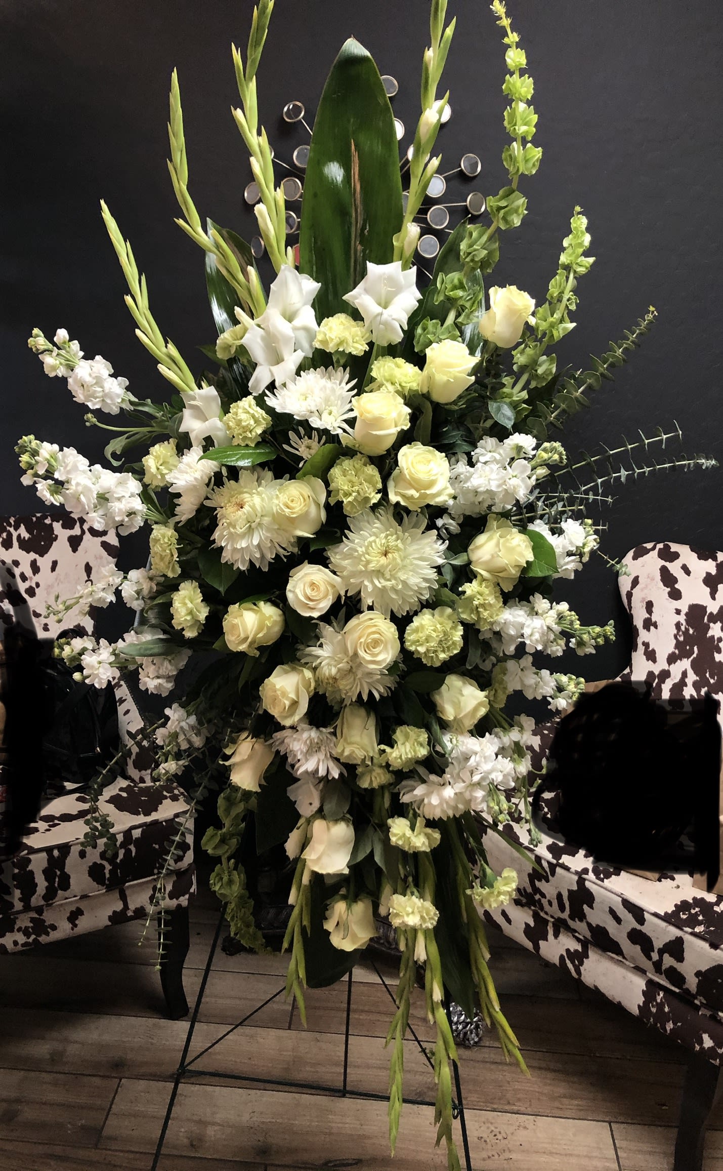 Tall white and pale yellow floral arrangement on a stand