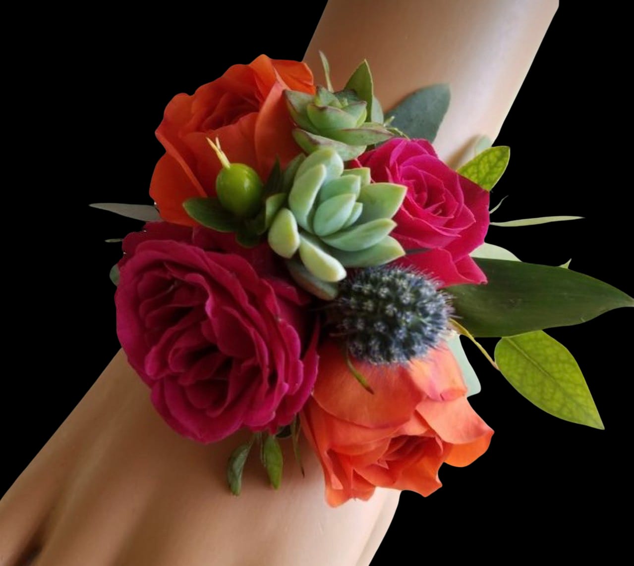 Wrist corsage with pink and orange roses and a small succulent