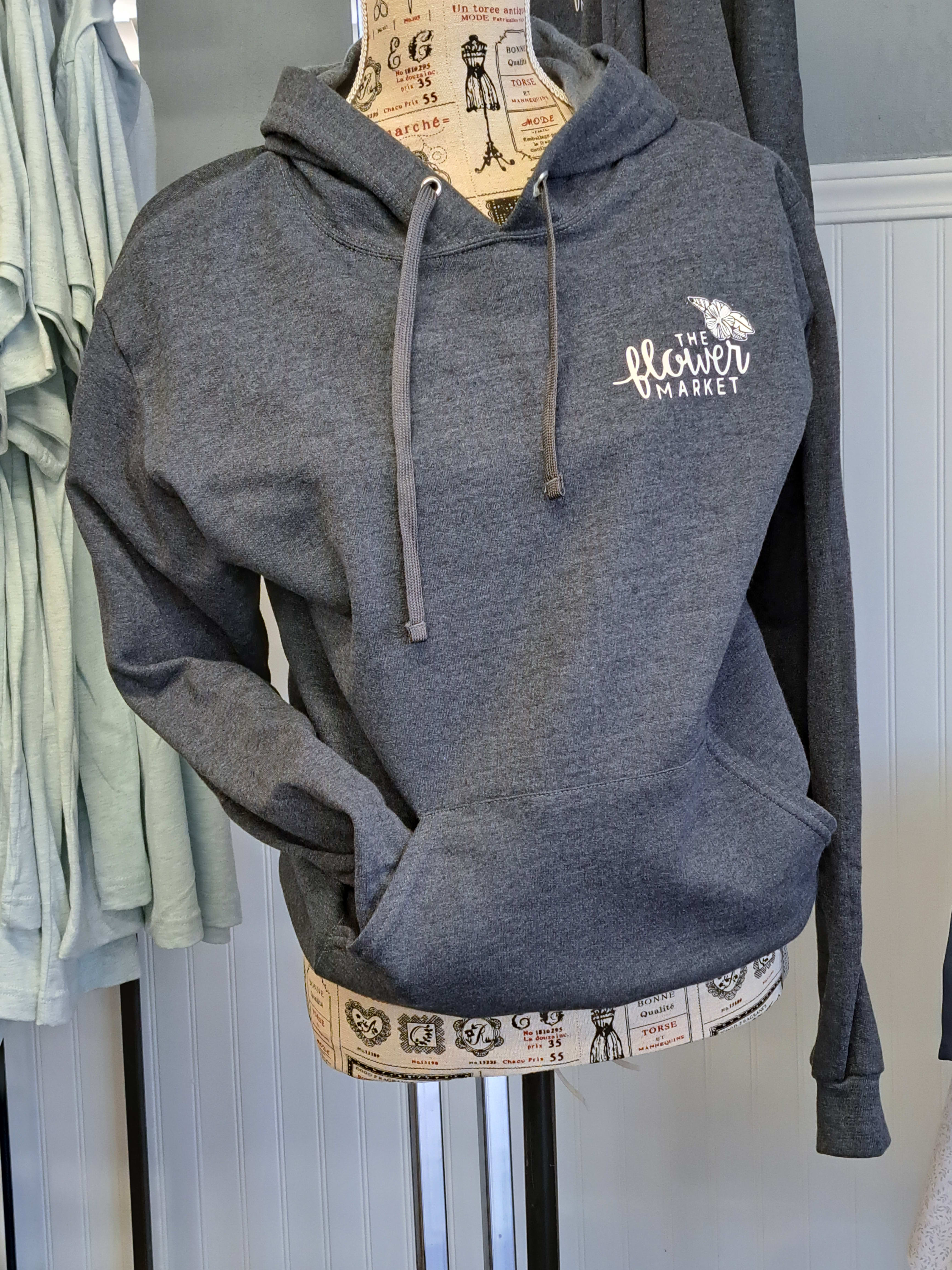 Gray hooded sweatshirt on a dress form with a flower market logo