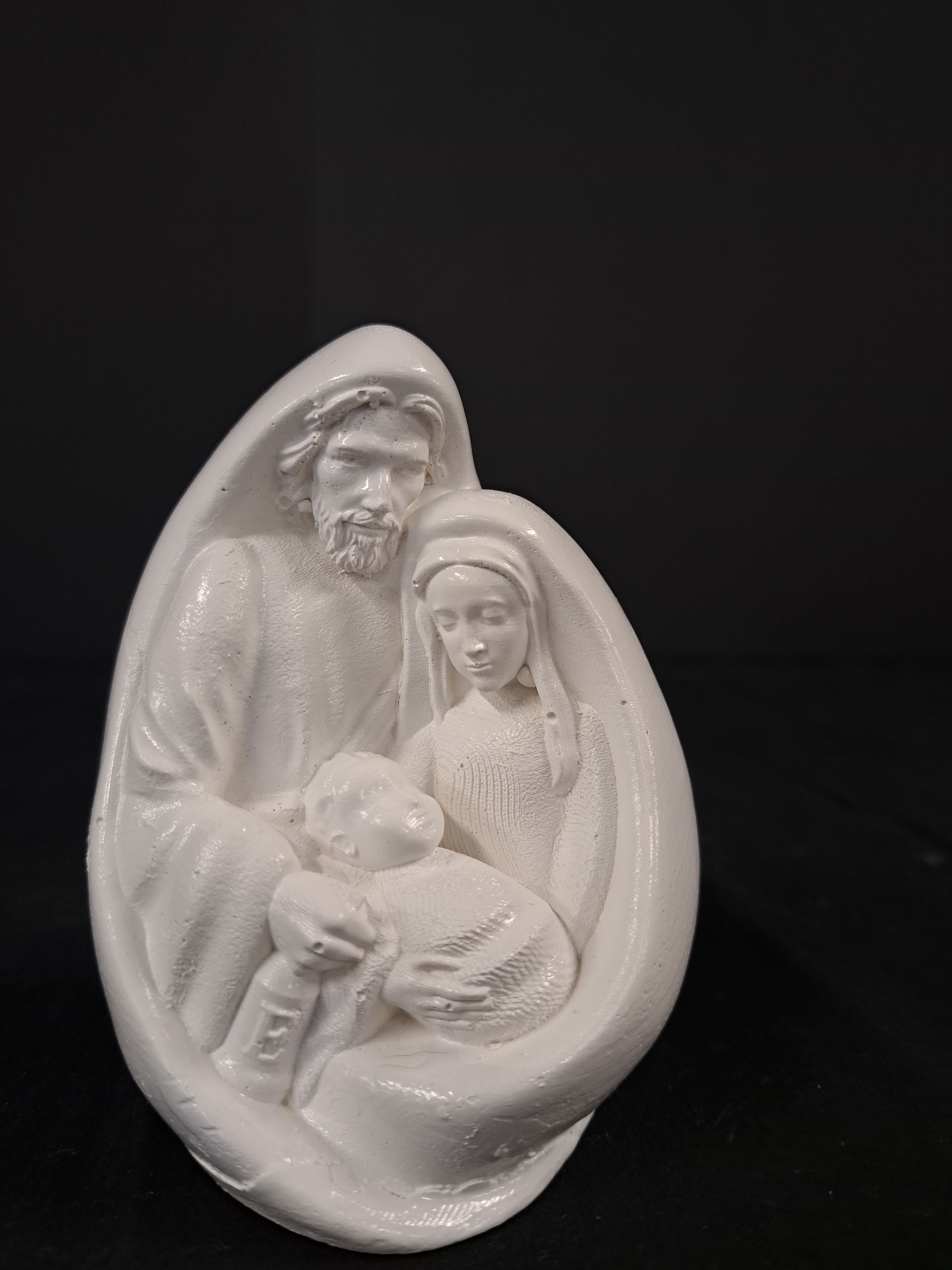 White nativity figurine of Mary, Joseph, and baby Jesus