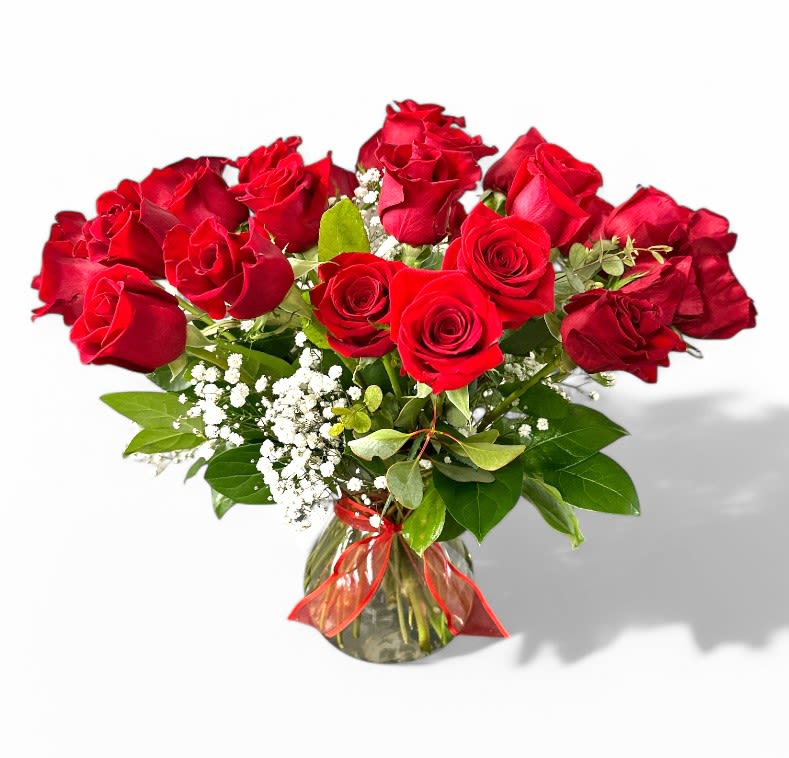 Bouquet of red roses in a glass vase with baby's breath