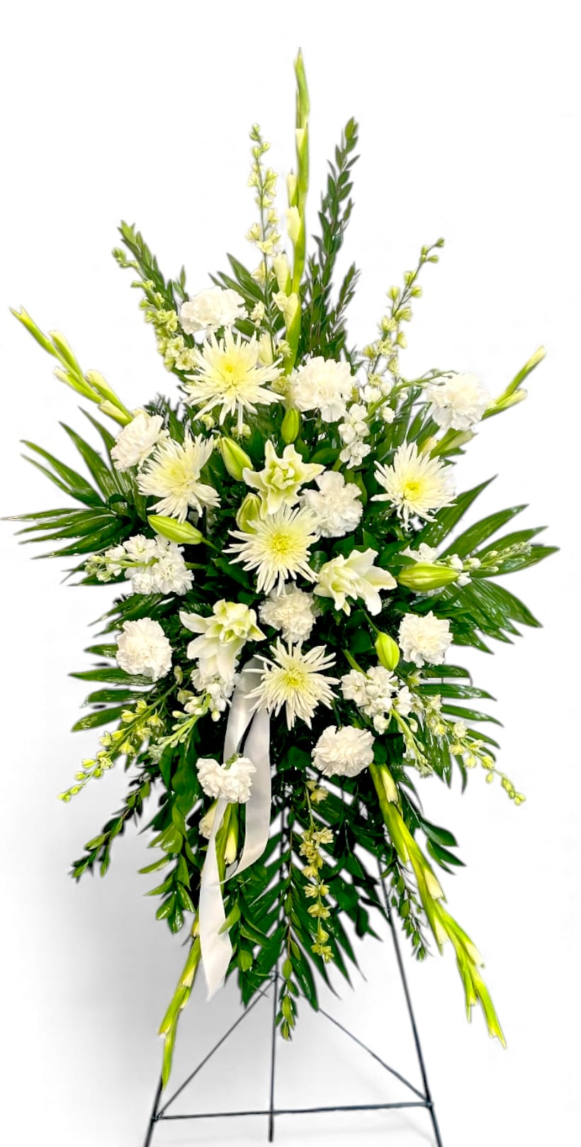 White floral standing spray on an easel with ribbon