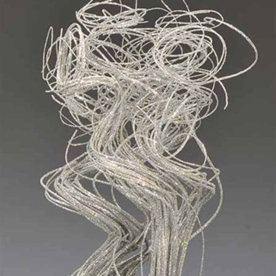 Bundle of silver decorative wire loops on a gray background