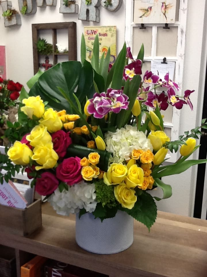 Garden Delight - This garden arrangement includes orchid plants that the recipient can plant in the garden for a lasting gift. Roses, spray roses, hydrangea, potted orchid, monstera leaves, tulips etc...