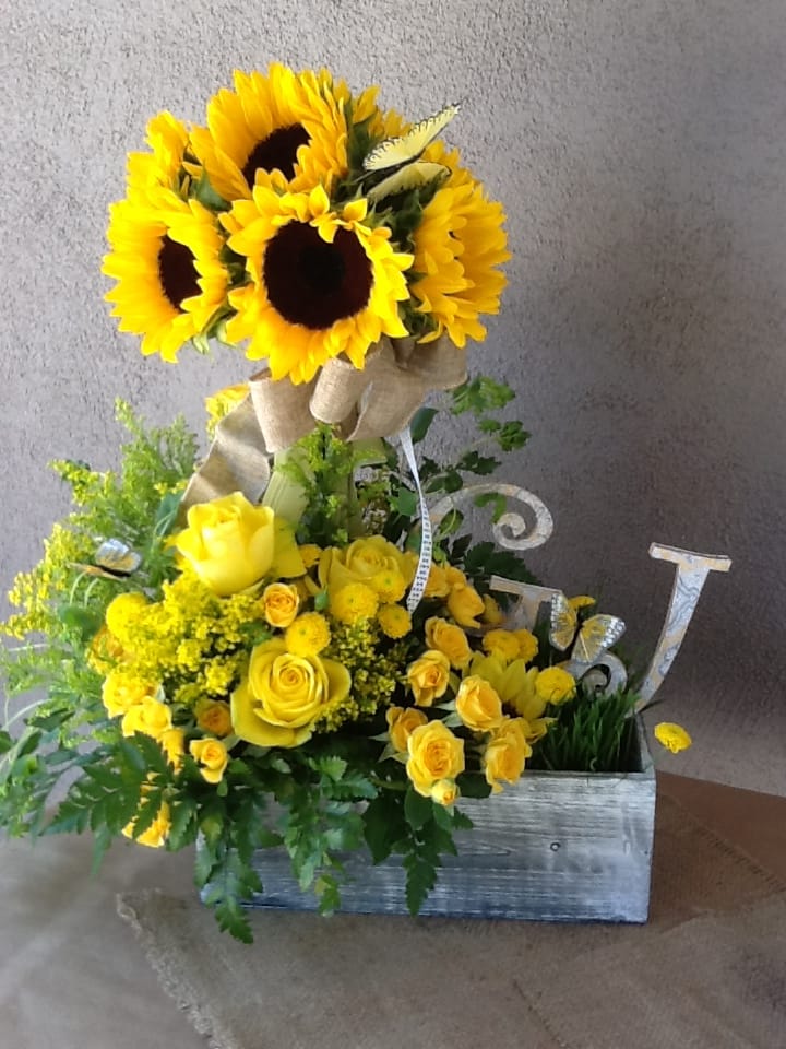 Yellow sunflower and rose arrangement in a wooden box