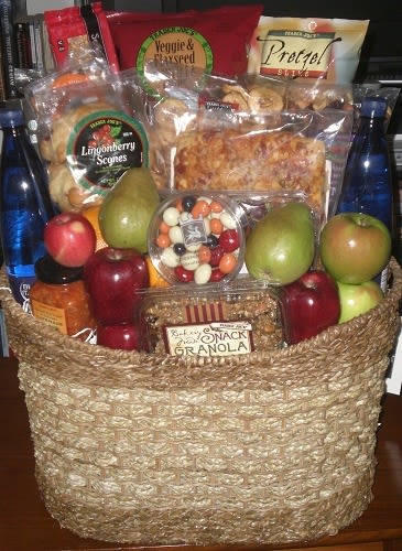 Gift basket with fruit, snacks, and bottled drinks