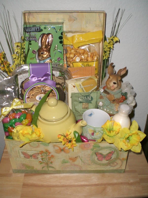 Gift basket with candy, tea, a teapot, and a bunny figurine