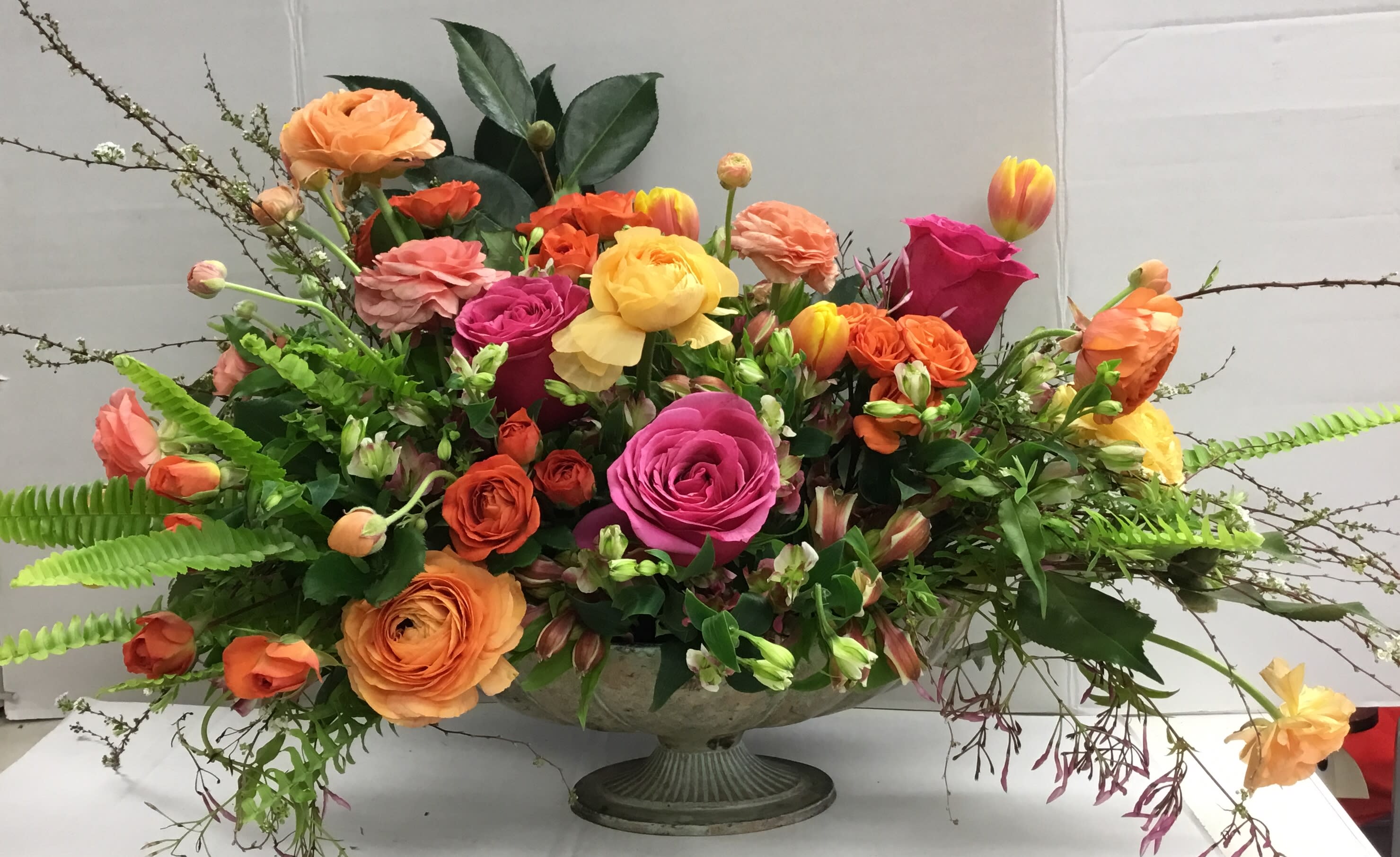 Mixed bouquet of roses and tulips in a pedestal bowl