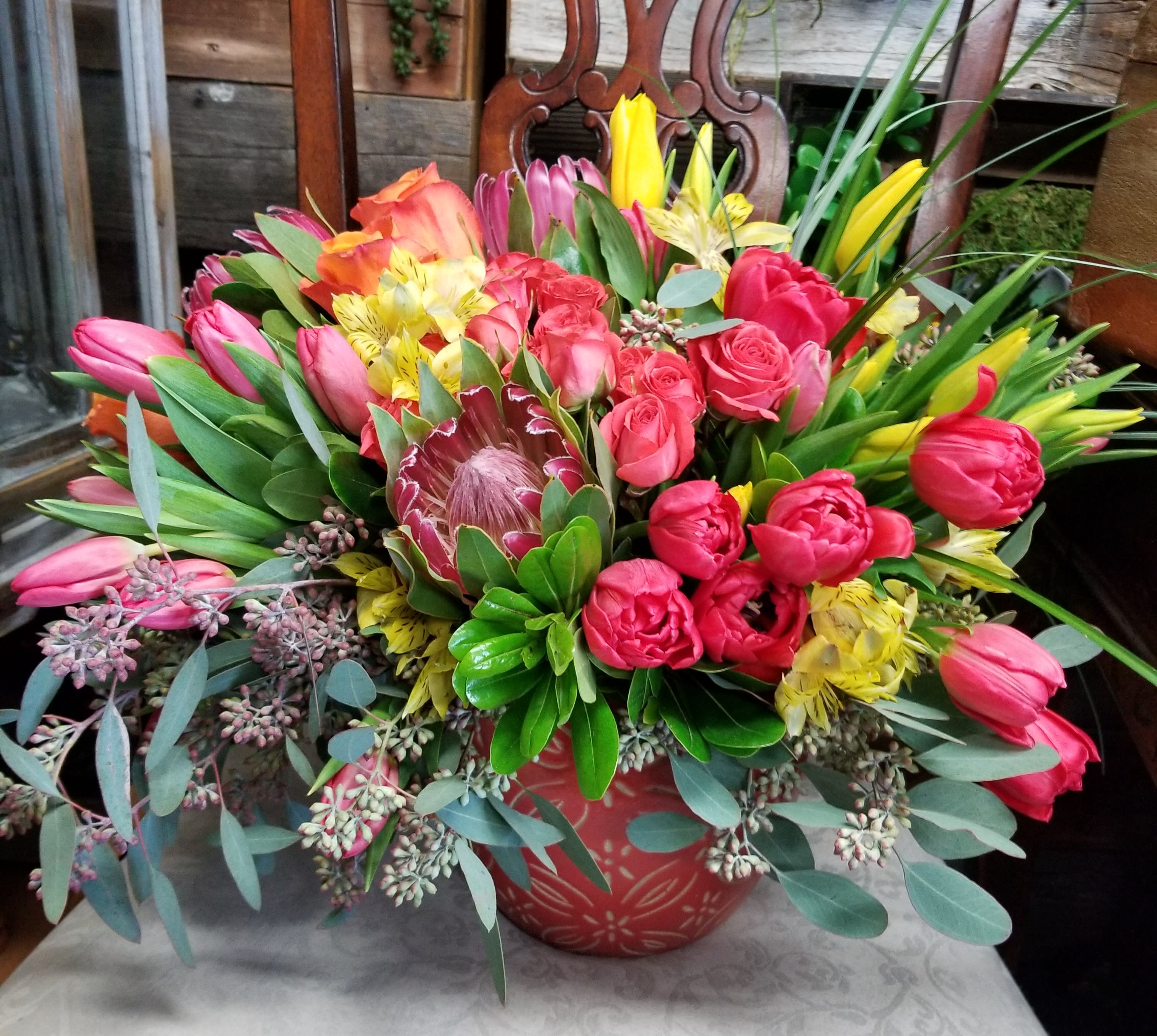 Bohemian 2 - Bright beautiful flowers arranged in a planter. Planter can be reused for your garden. Tulips, roses, protea, spray roses, eucalyptus, alstromeria etc...