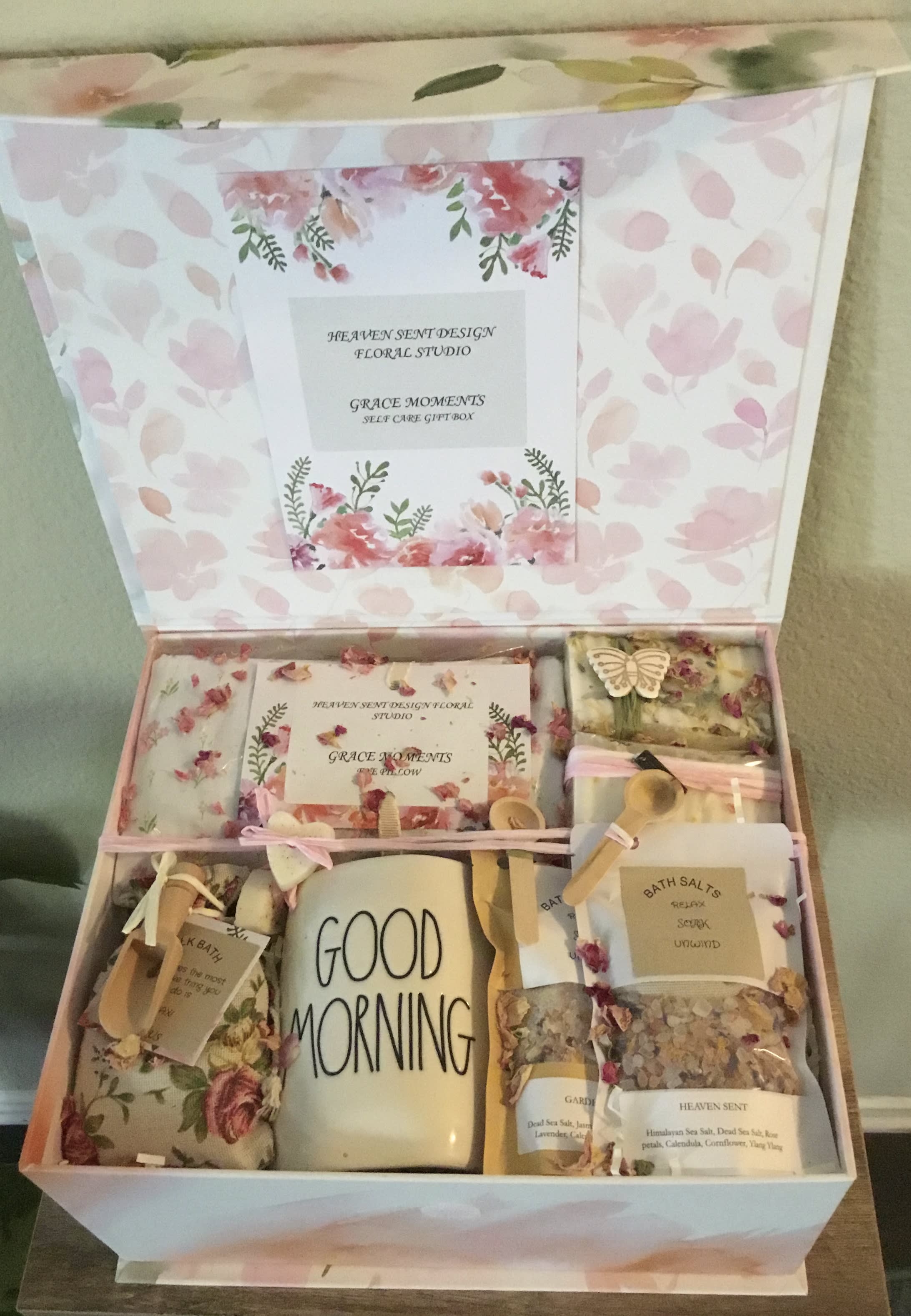 Floral gift box with bath items and a mug labeled Good Morning