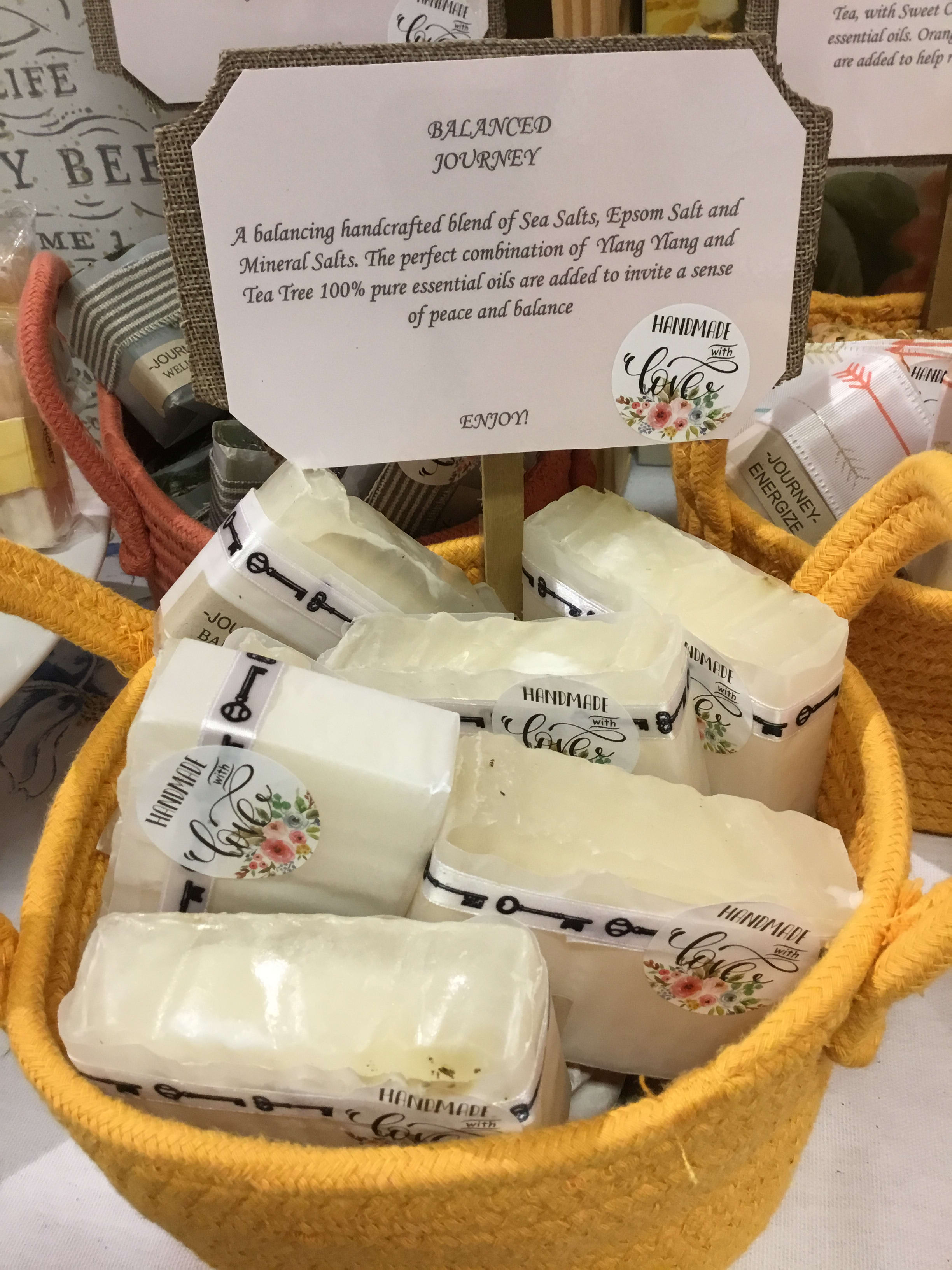 Basket of wrapped bath salt bars with a sign reading Balanced Journey