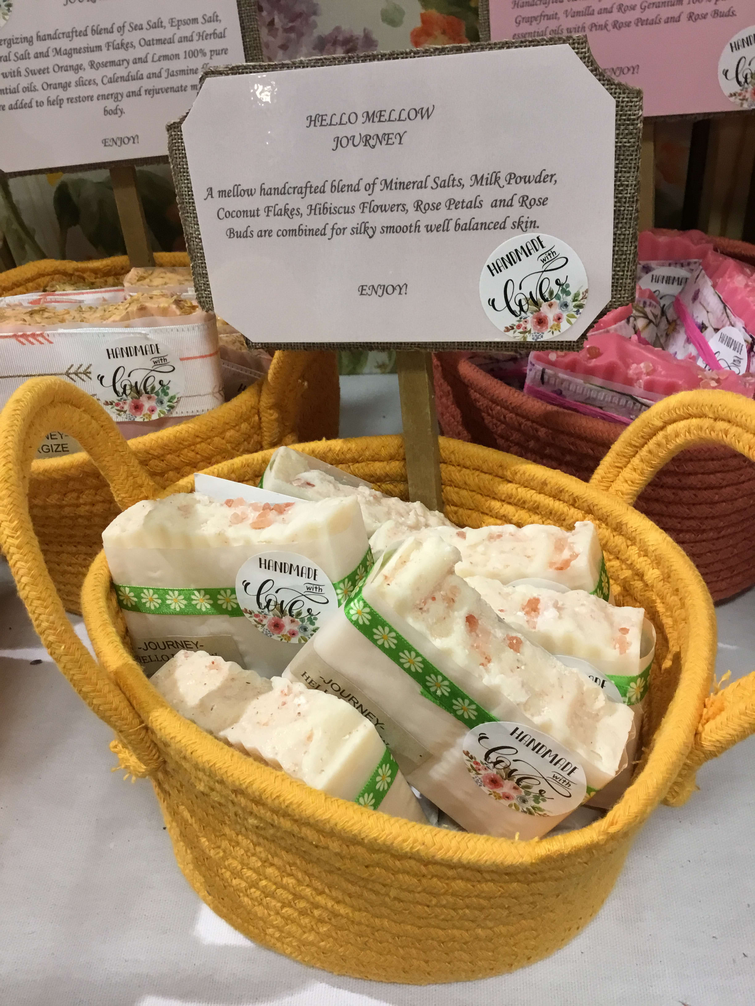 Basket of handmade soap bars with a product sign