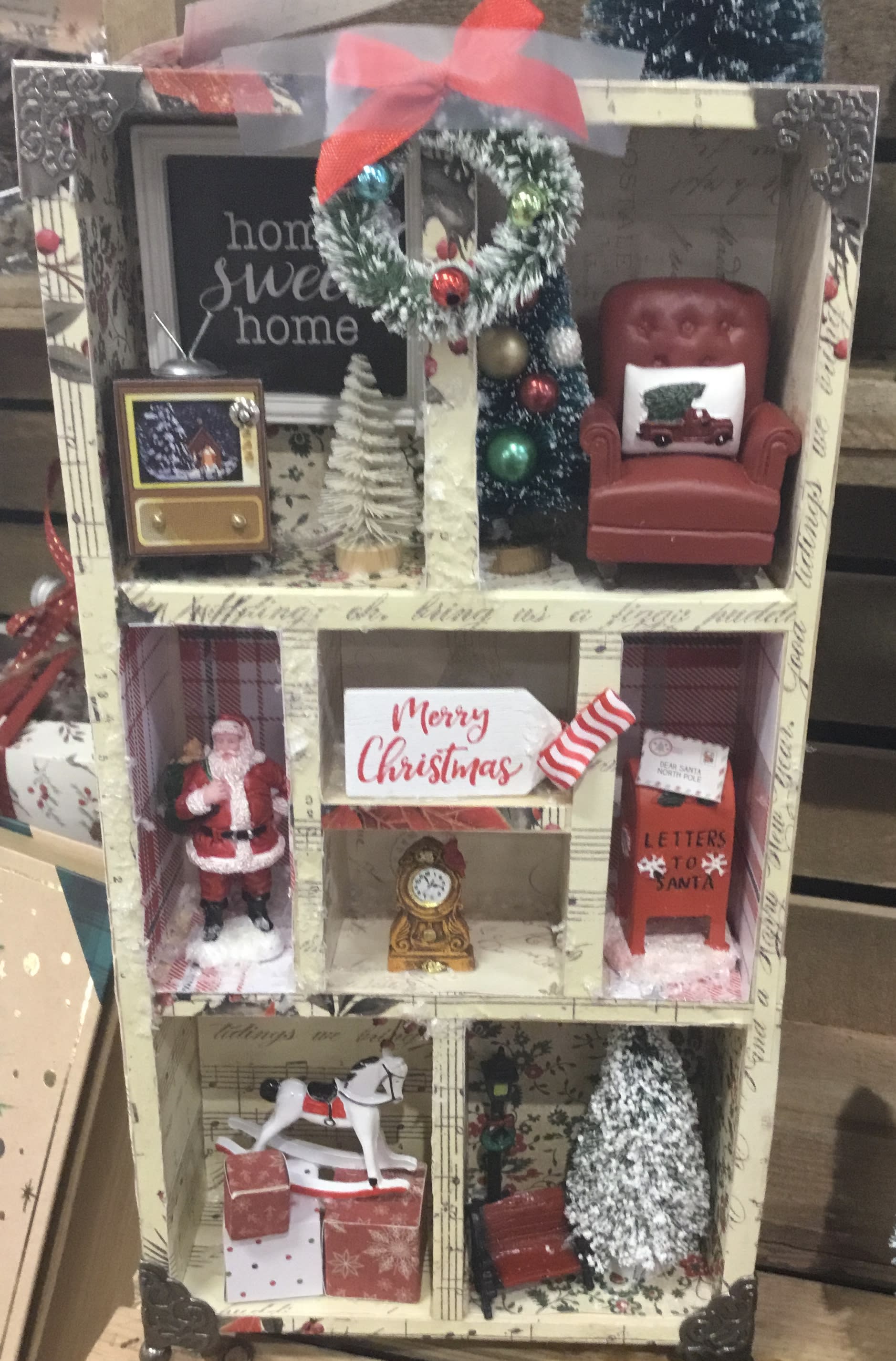 Miniature Christmas room display with Santa, a chair, and holiday decor