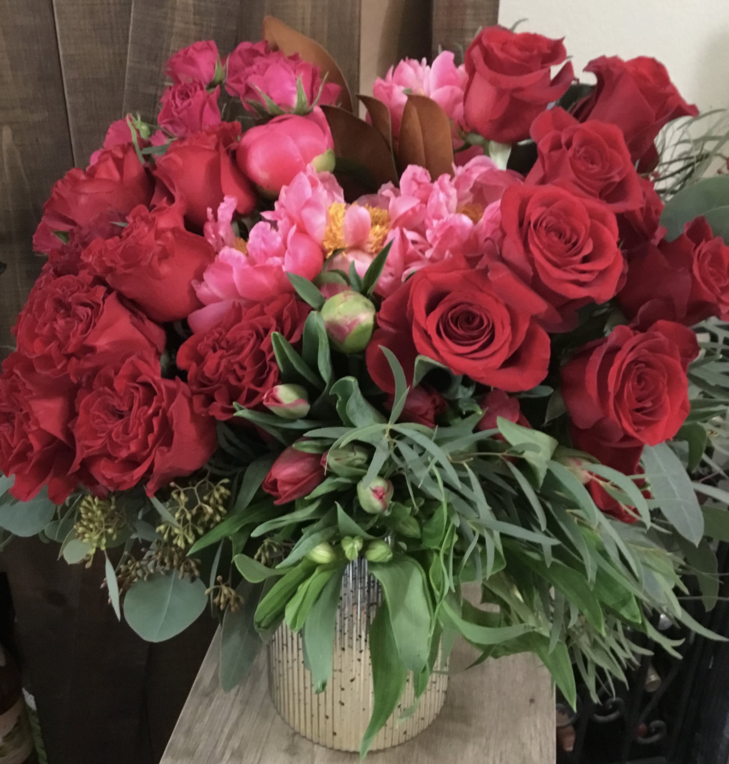 Bouquet of red and pink roses in a striped vase
