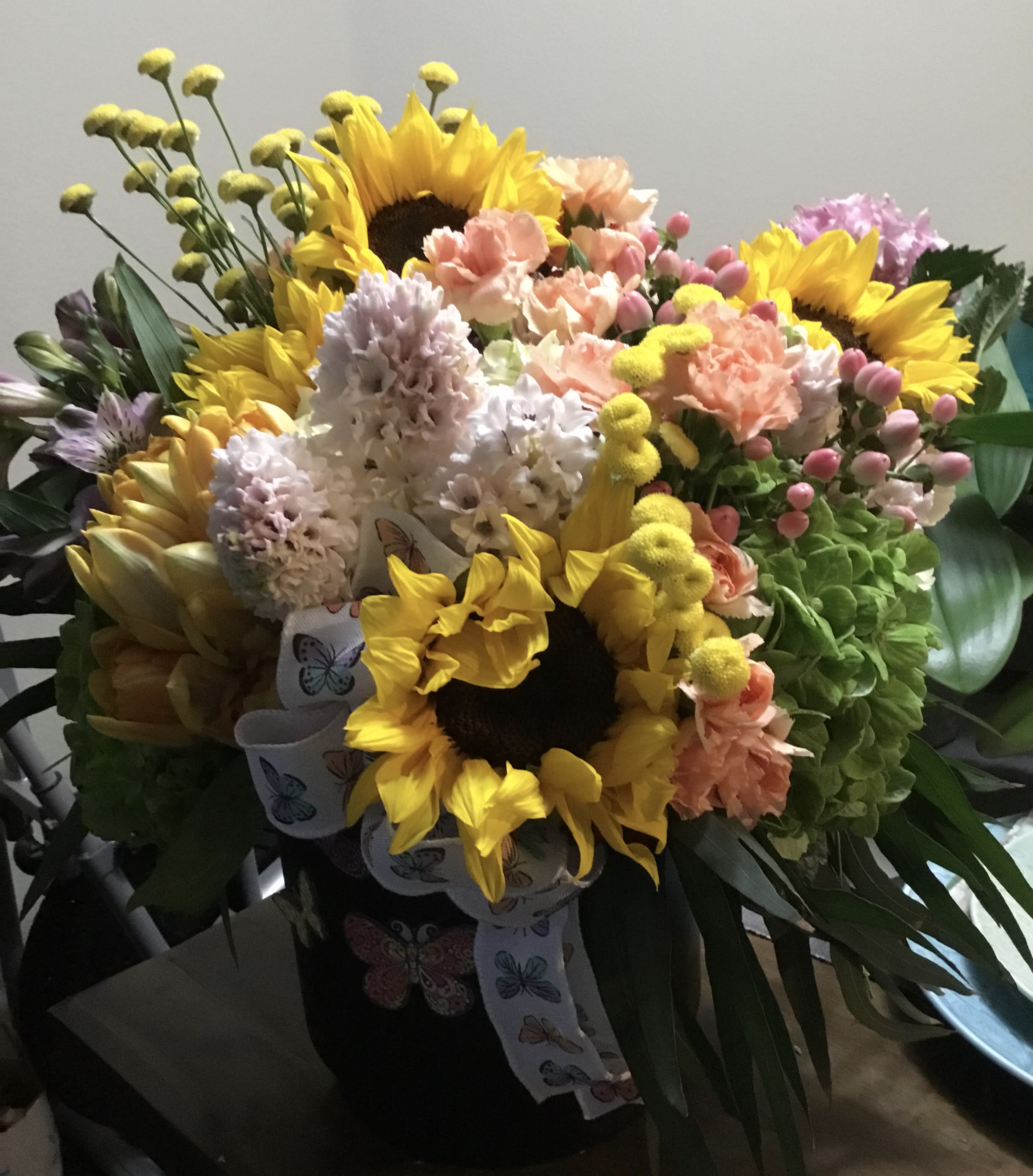 Bouquet with sunflowers, pastel carnations, and hyacinths