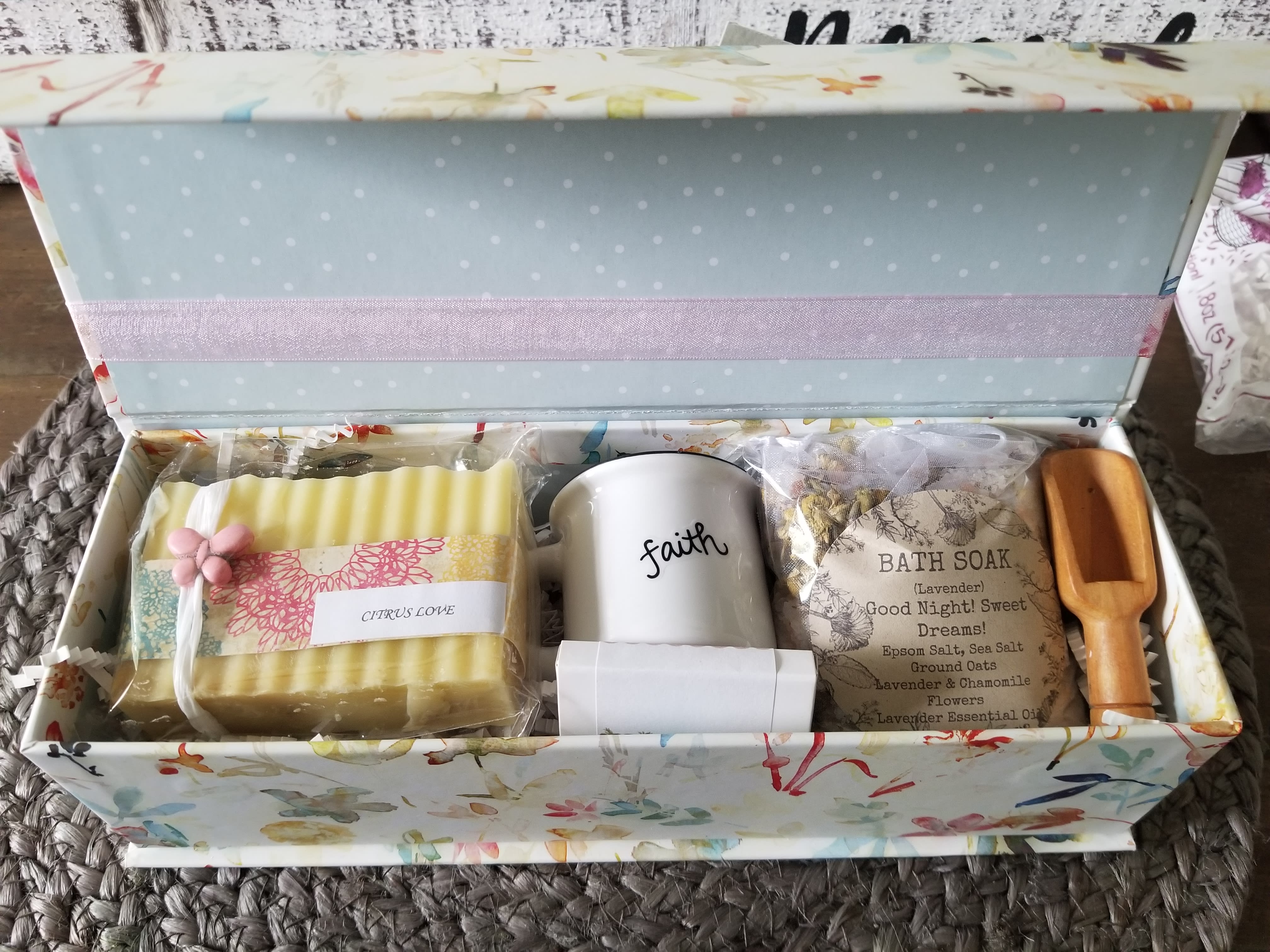 Gift box with soap, a mug, bath soak, and a wooden scoop