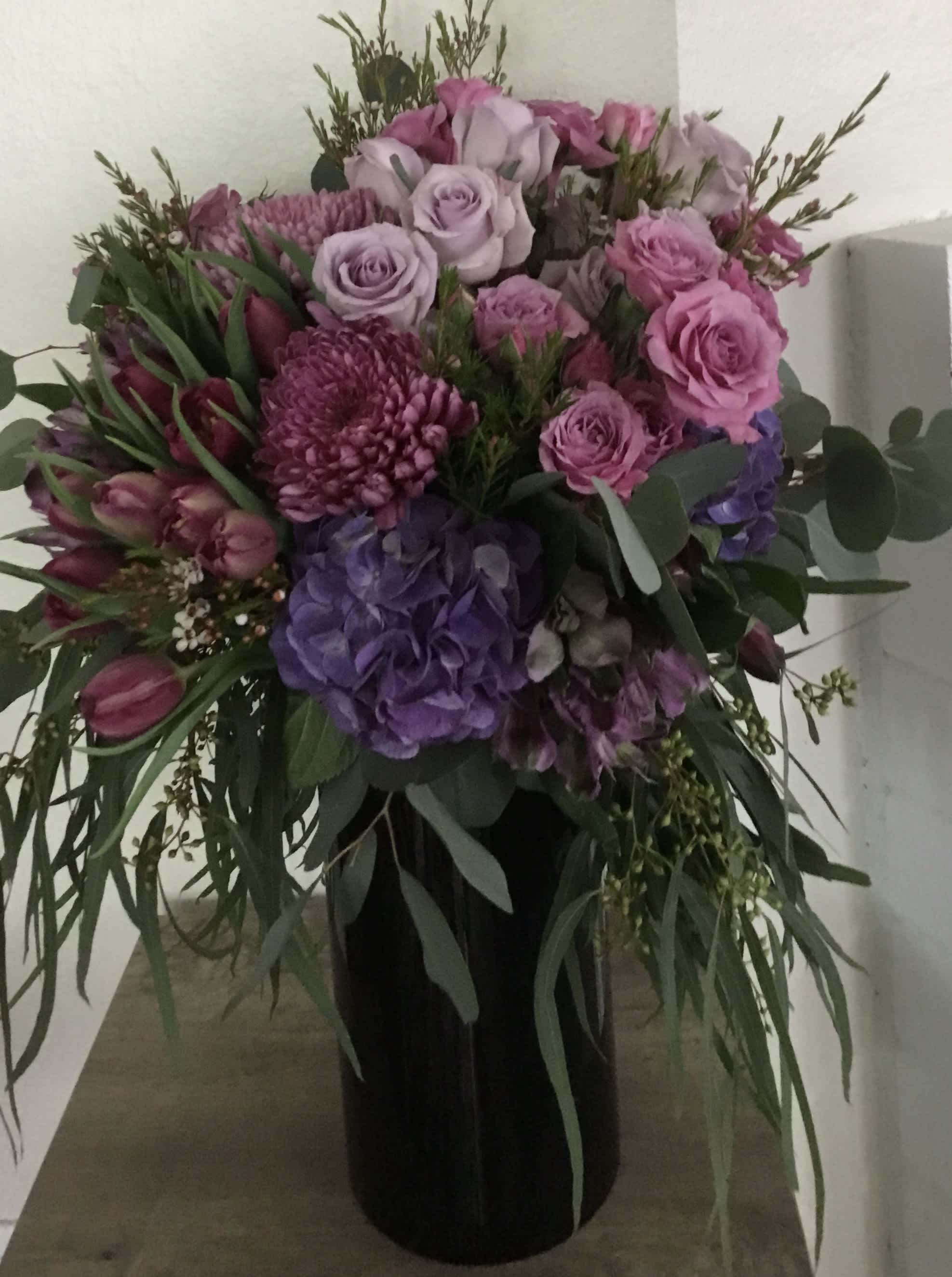 Pink and purple mixed bouquet in a black vase
