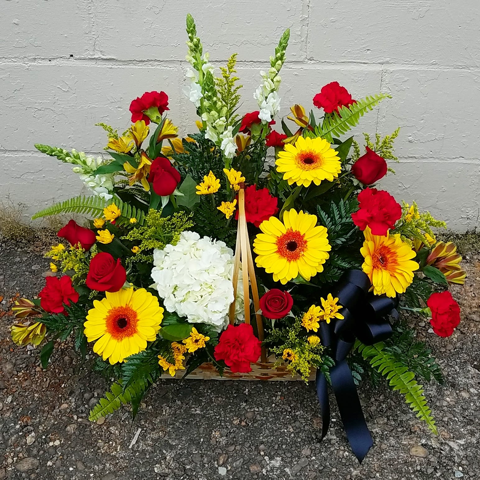 Maryland Pride Basket - A beautiful basket in shades of red, white and yellow with a black bow accent.