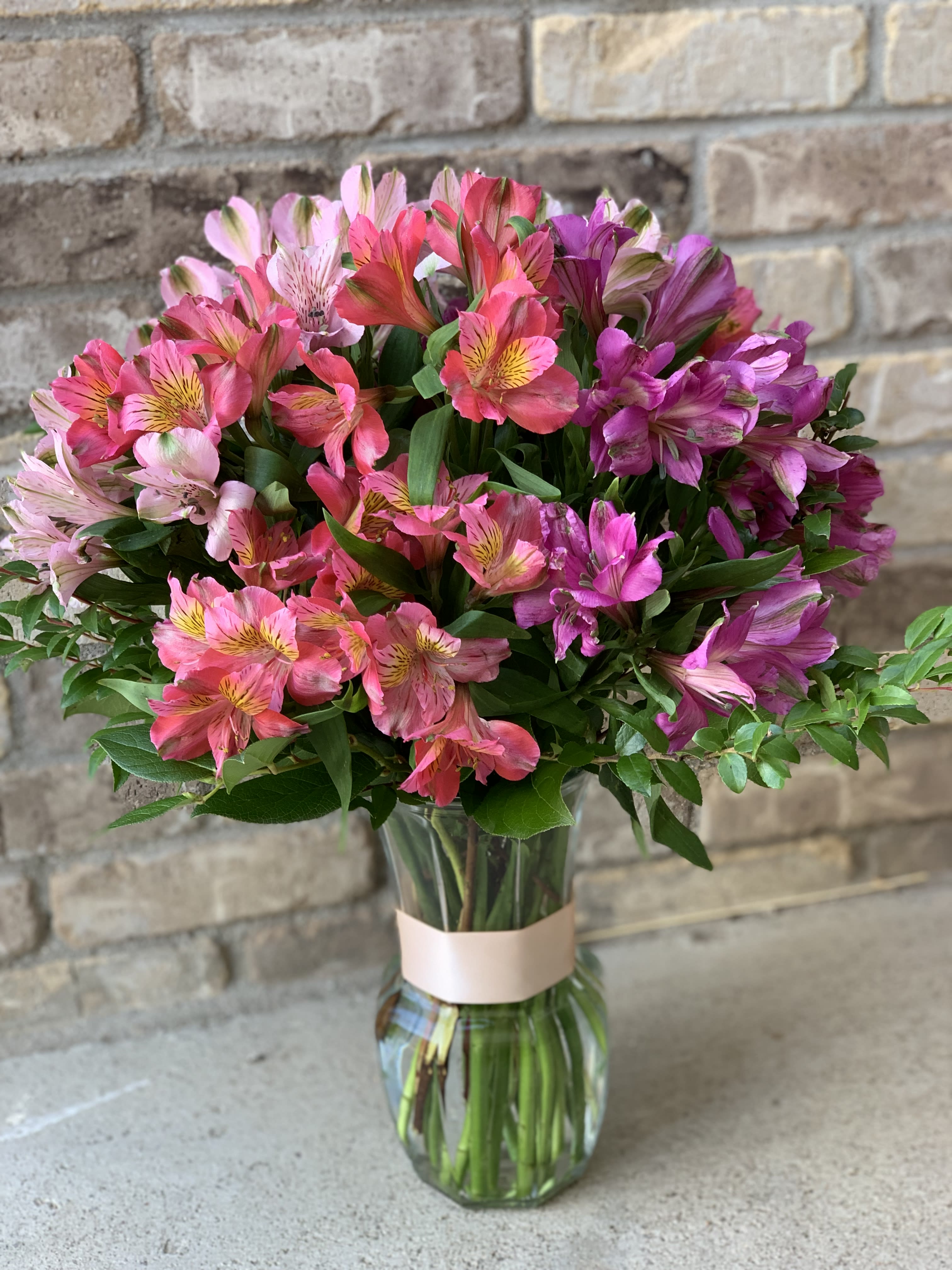 Bouquet of pink and purple alstroemeria in a glass vase