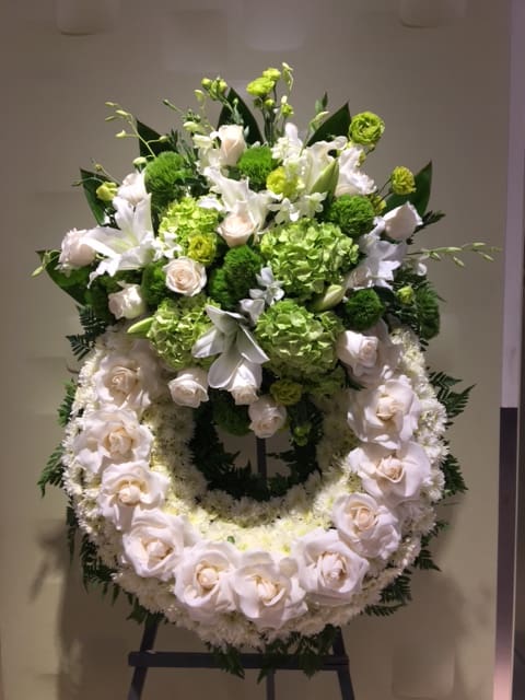 Standing floral wreath with white roses and green blooms