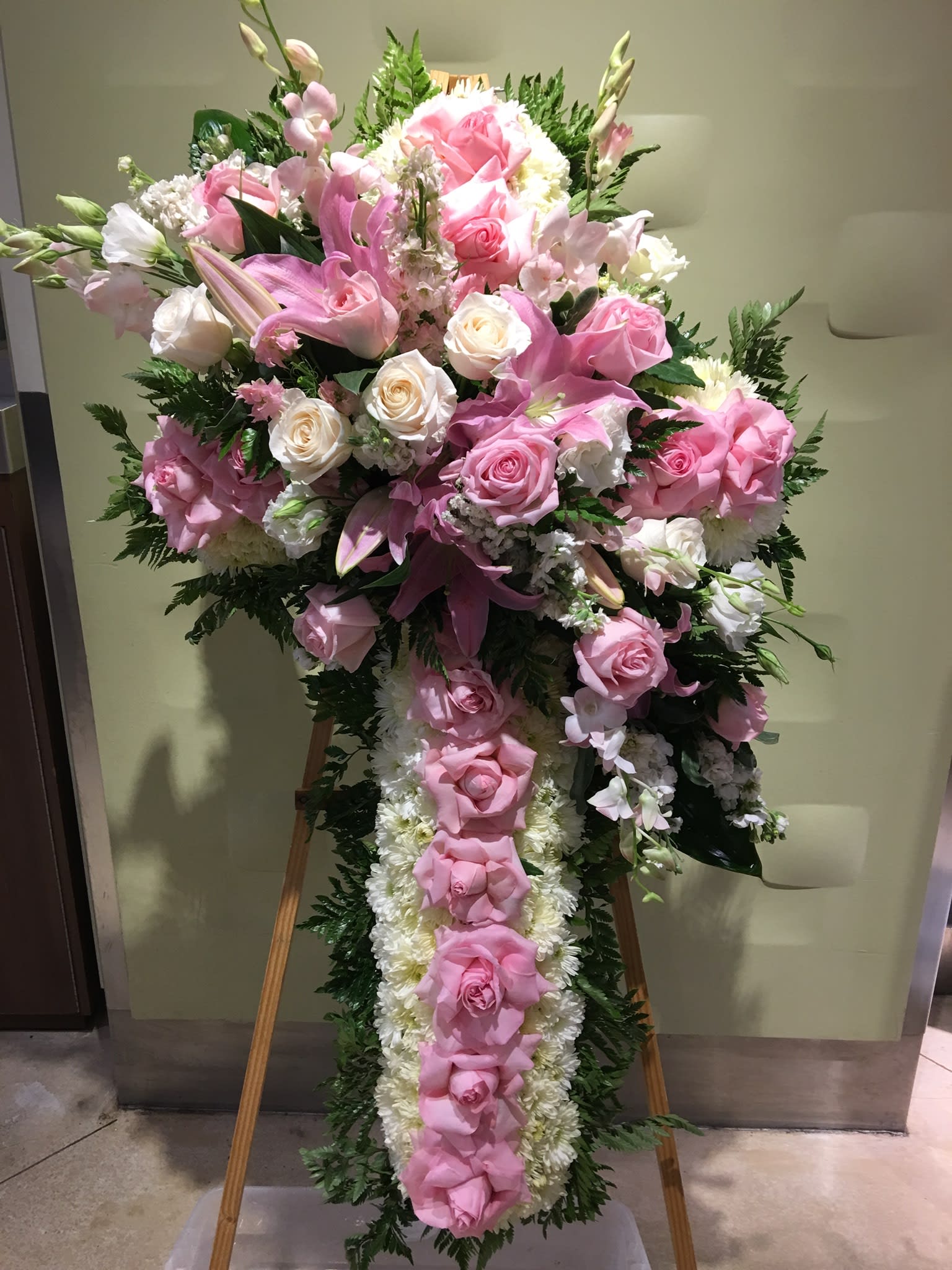Large pink and white floral standing spray on an easel