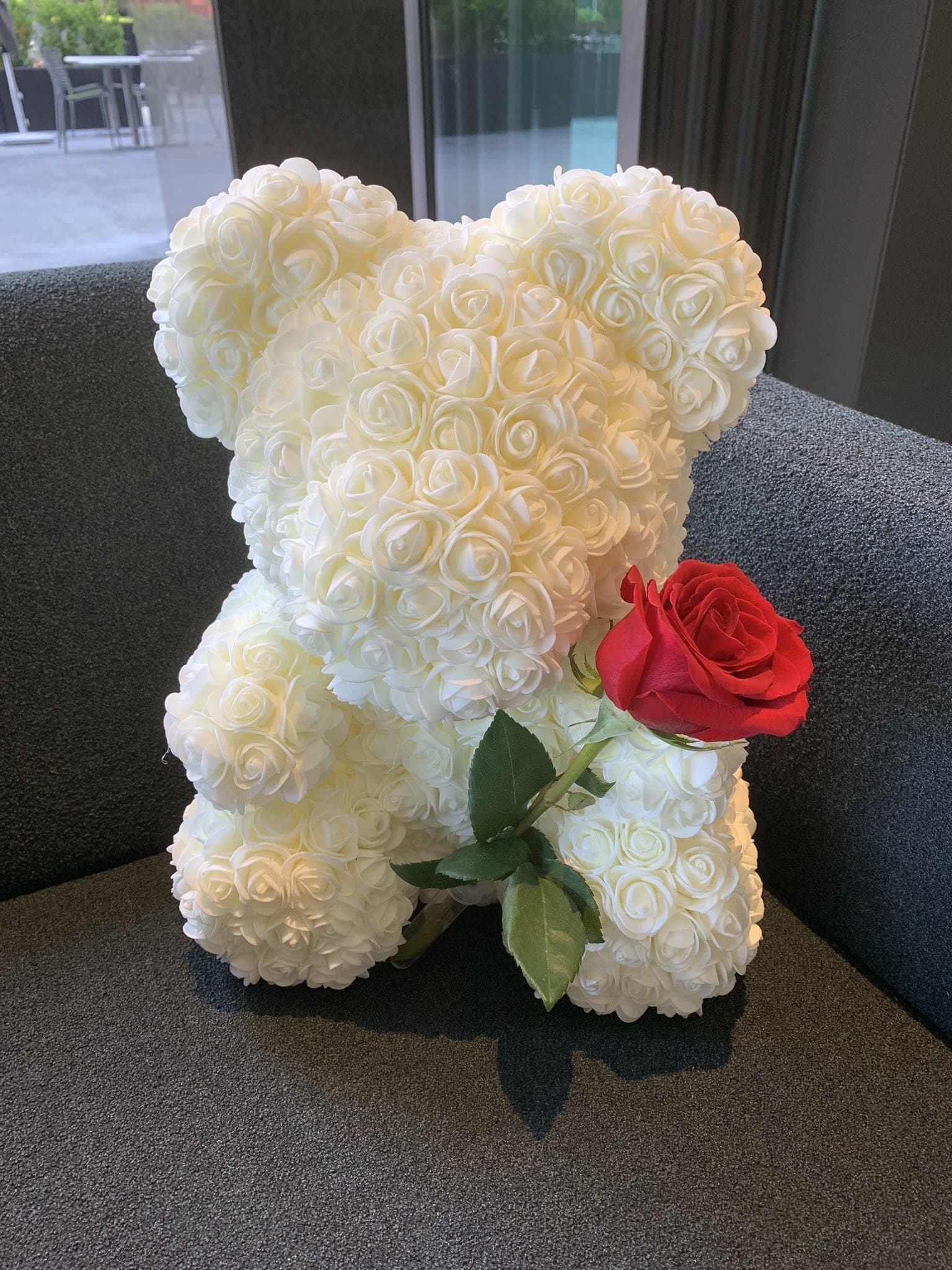 White rose teddy bear with a red rose accent