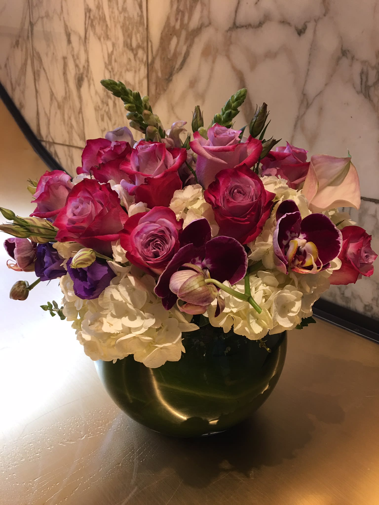 Pink and purple mixed bouquet in a dark vase