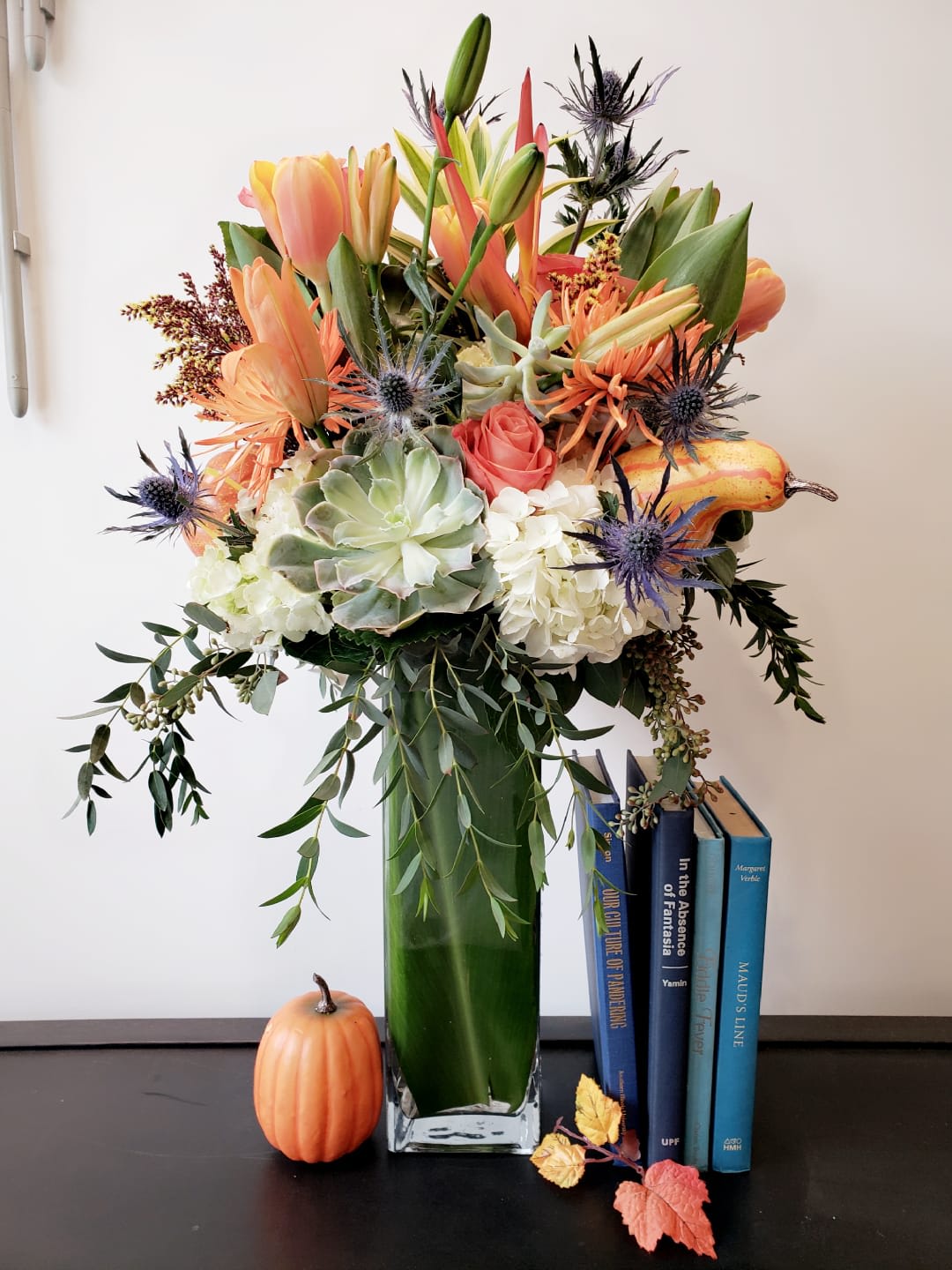 Fall in Los Angeles  - Amazing fall flowers set in a tall glass vase accent with fall gourds and other fall decors    