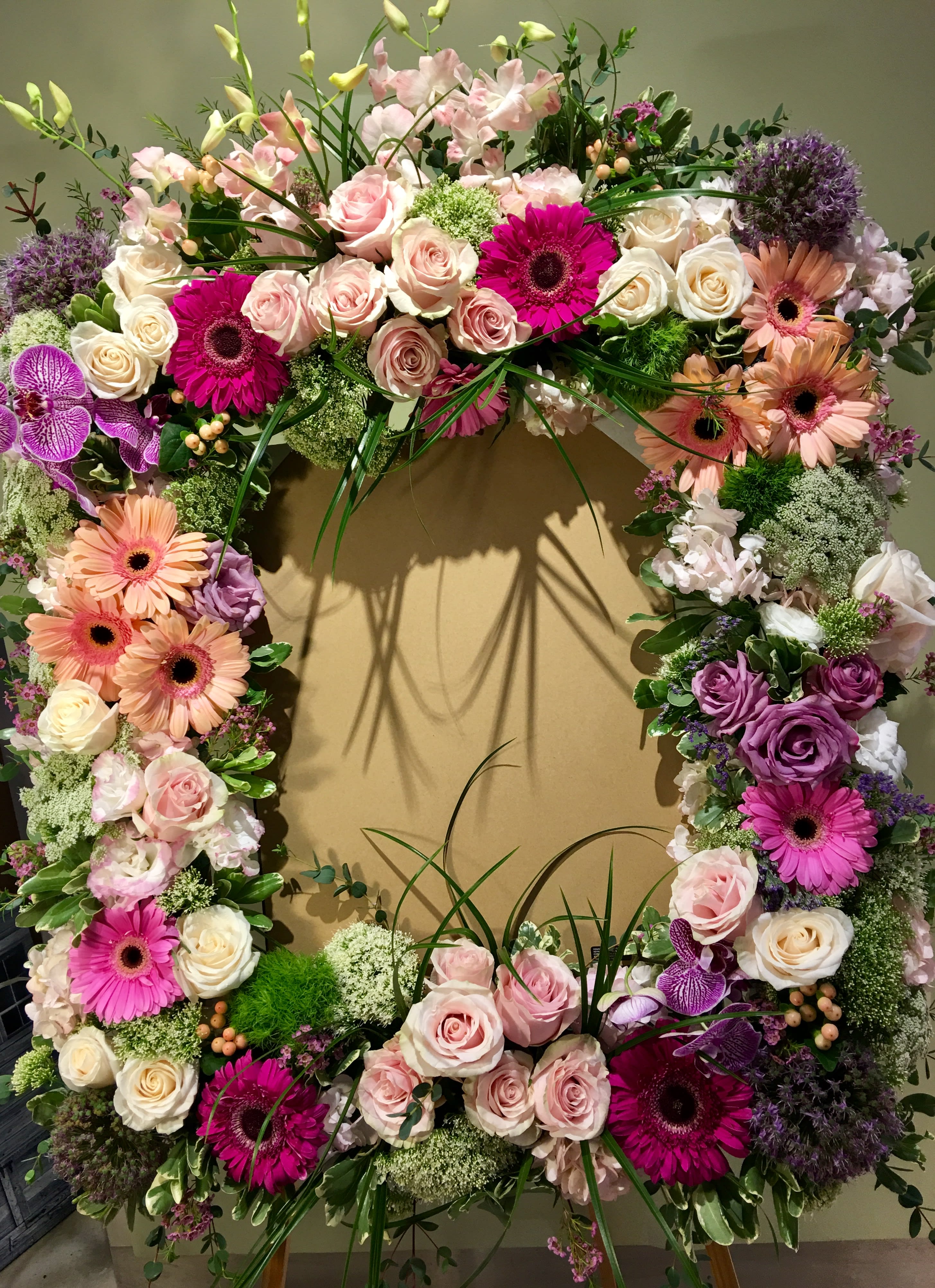 Large floral wreath with pink, white, and purple blooms