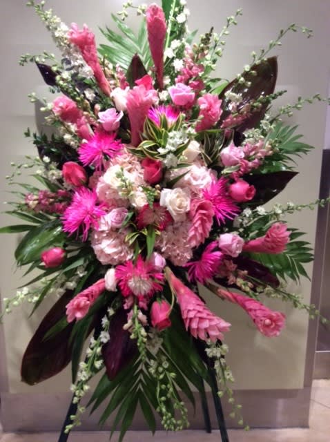 Tall pink floral standing spray with roses and lilies