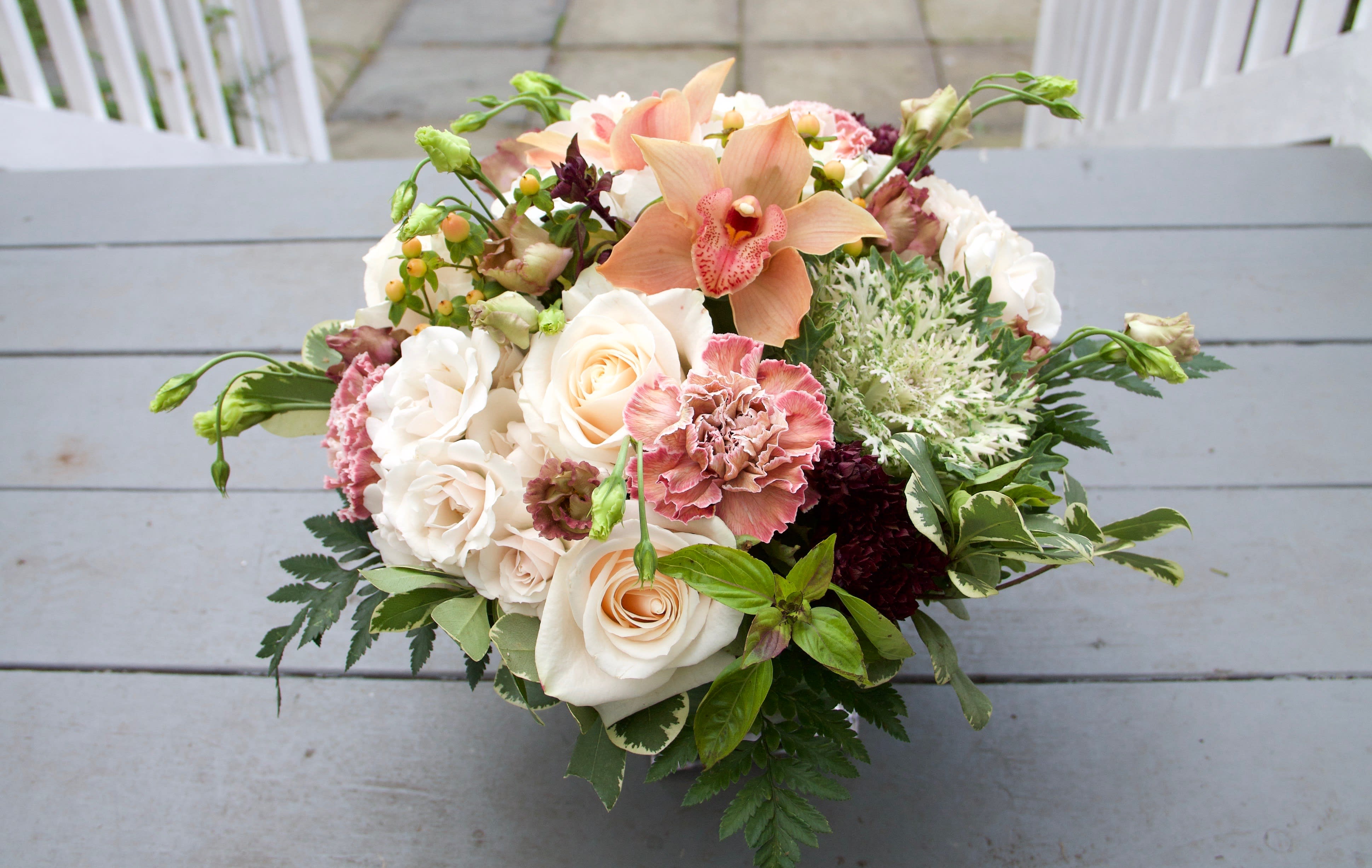 Peach and white floral bouquet with roses and orchids