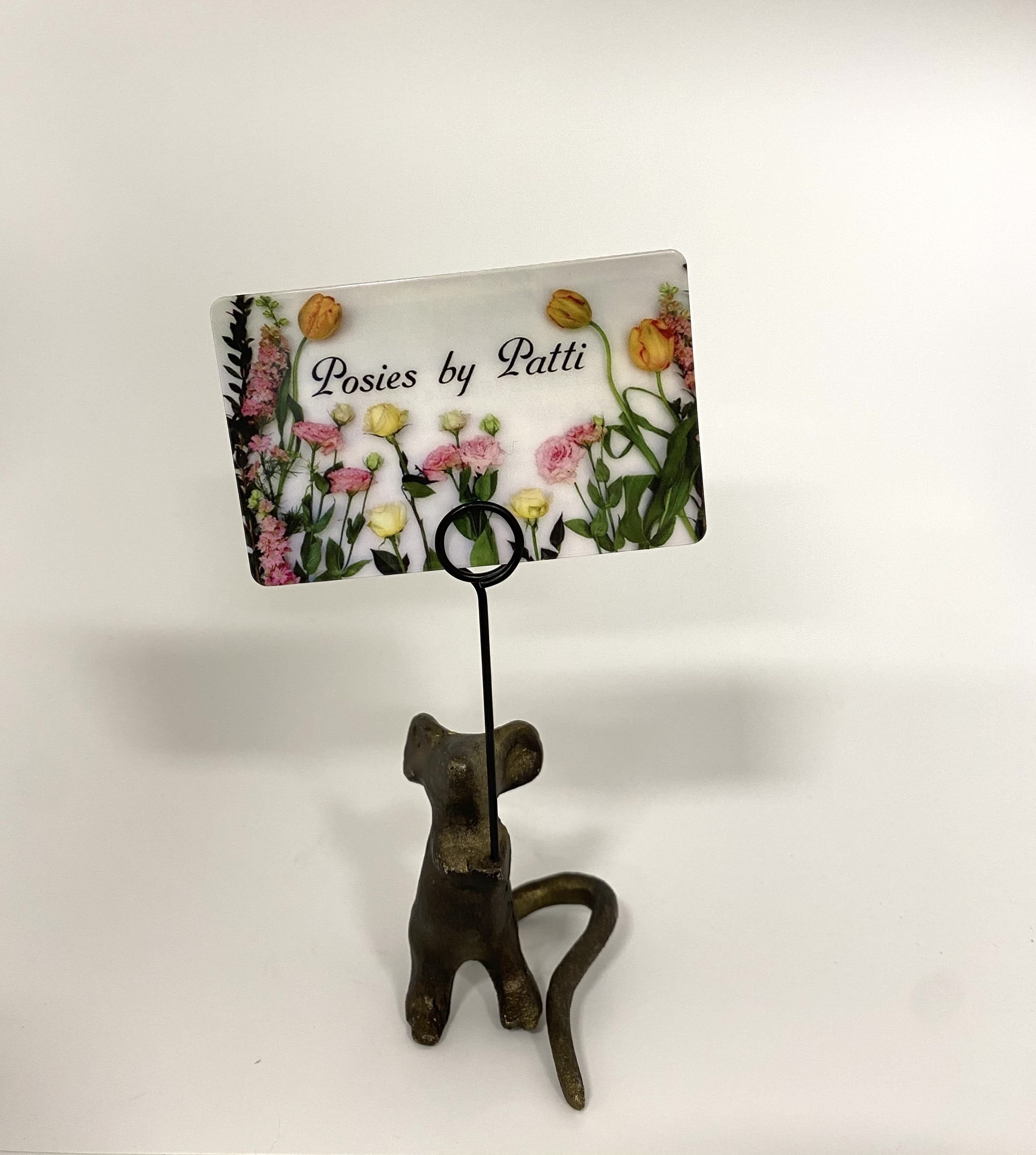 Decorative card holder with a floral business card and cat figurine base