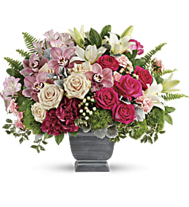 Mixed pink and white floral arrangement in a gray vase