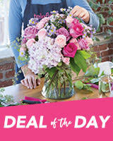 Pink and lavender bouquet in a glass vase on a table